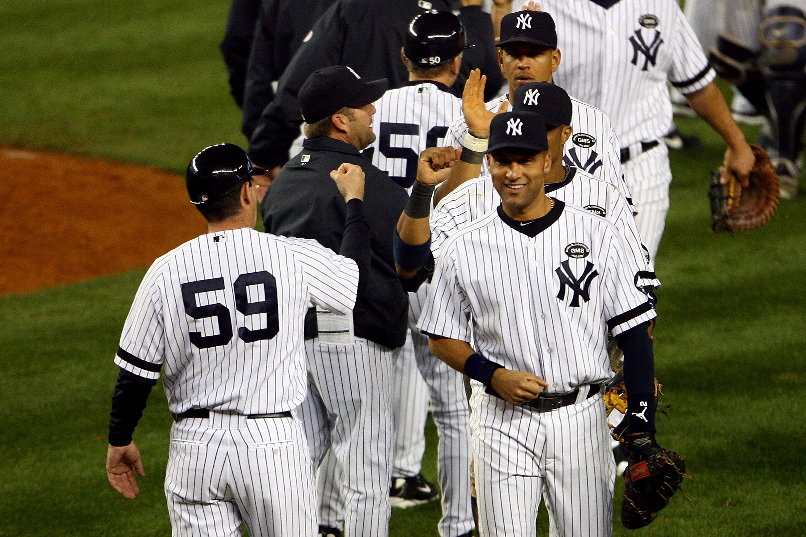NEW YORK - OCTOBER 20: Derek Jeter #2 of the New York Yankees celebrates with his teammates after the Yankees won 7-2 against the Texas Rangers in Game Five of the ALCS during the 2010 MLB Playoffs at Yankee Stadium on October 20, 2010 in the Bronx borou NEW YORK - OCTOBER 20: Derek Jeter #2 of the New York Yankees celebrates with his teammates after the Yankees won 7-2 against the Texas Rangers in Game Five of the ALCS during the 2010 MLB Playoffs at Yankee Stadium on October 20, 2010 in the Bronx borou