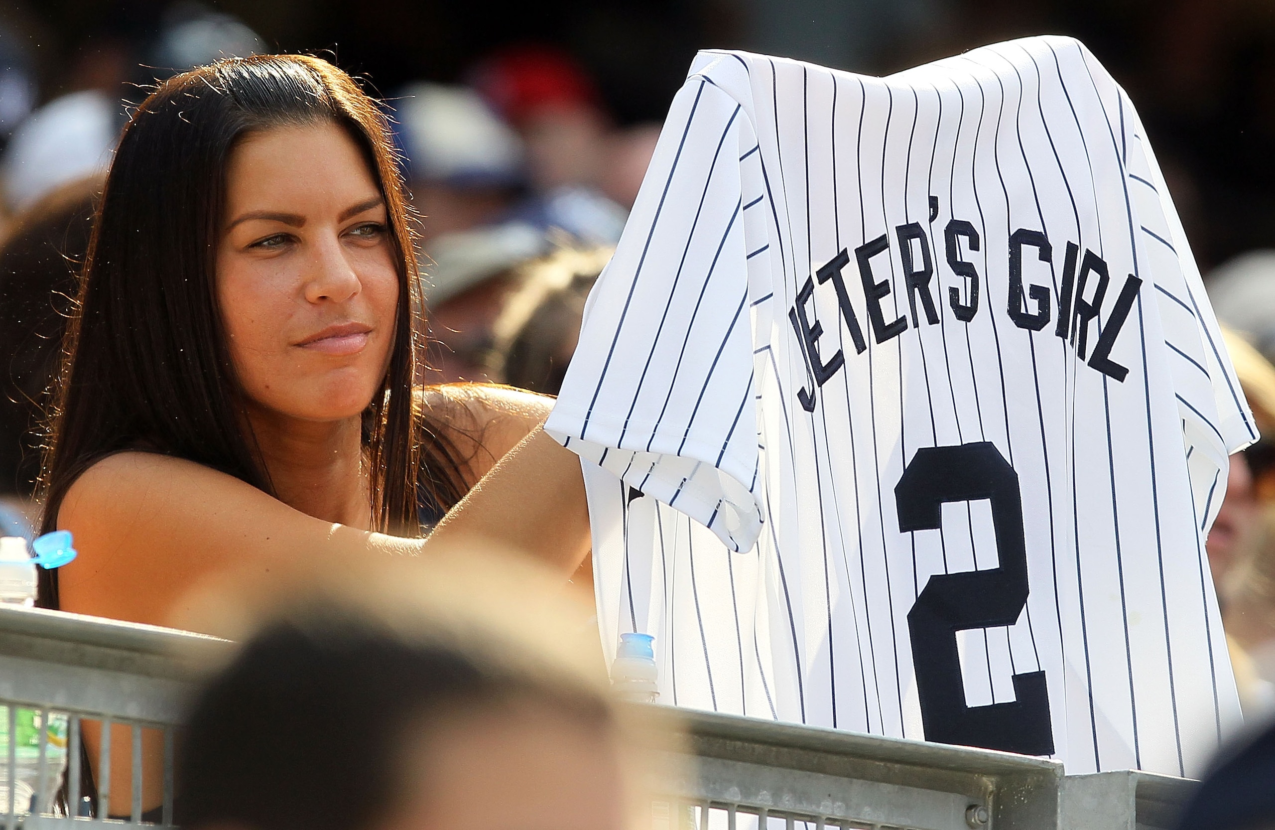 NEW YORK - JULY 18: A fan of Derek Jeter of the New York Yankees holds up a jersey during the game against the Tampa Bay Rays on July 18, 2010 at Yankee Stadium in the Bronx borough of New York City. The Yankees defeated the Rays 9-5. (Photo by Jim McIs NEW YORK - JULY 18: A fan of Derek Jeter of the New York Yankees holds up a jersey during the game against the Tampa Bay Rays on July 18, 2010 at Yankee Stadium in the Bronx borough of New York City. The Yankees defeated the Rays 9-5. (Photo by Jim McIs