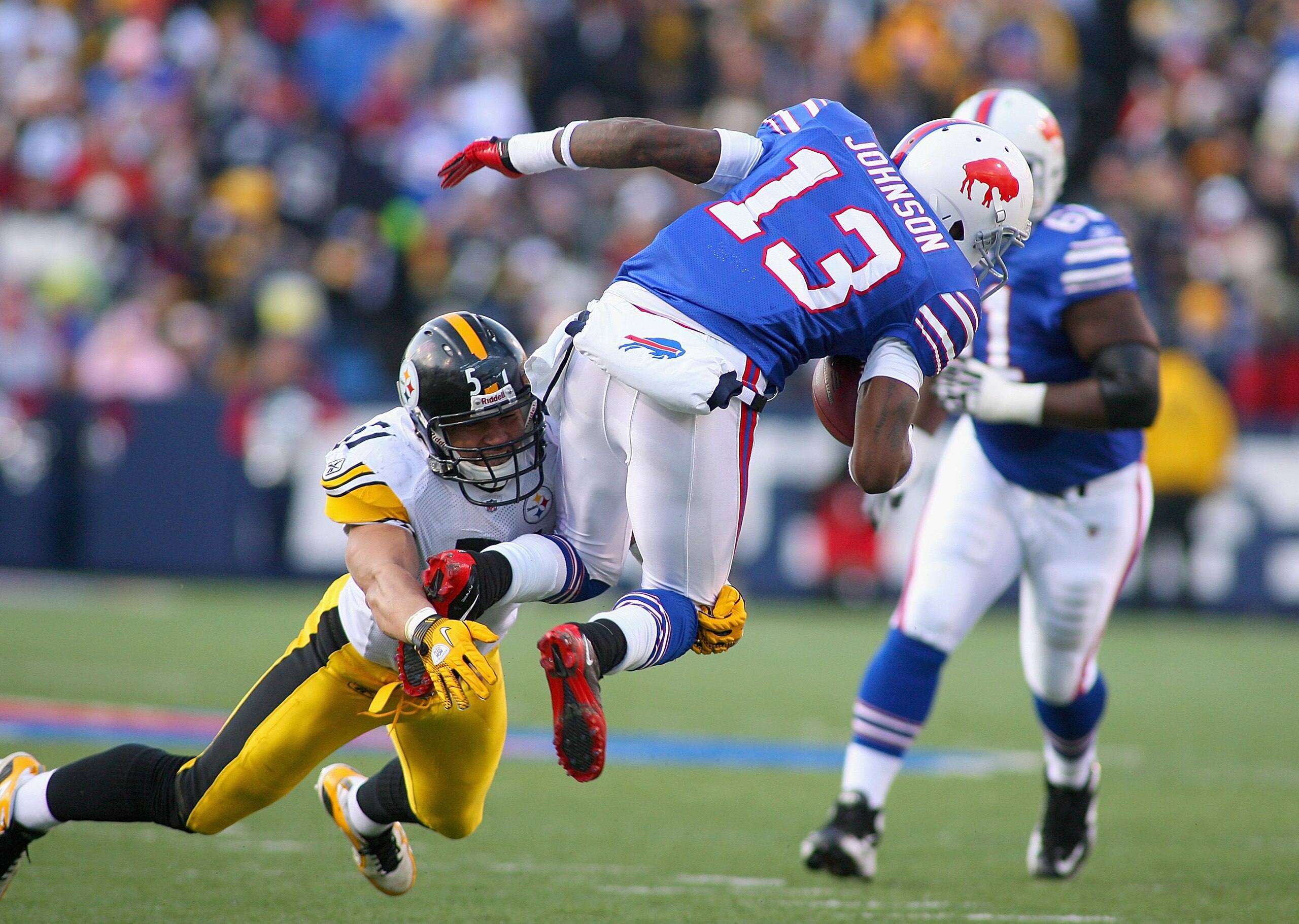 ORCHARD PARK, NY - NOVEMBER 28:  Steve Johnson #13 of the Buffalo Bills is tackled James Farrior #51 of the Pittsburgh Steelers at Ralph Wilson Stadium at Ralph Wilson Stadium on November 28, 2010 in Orchard Park, New York.Pittsburgh won 19-16 in overtime