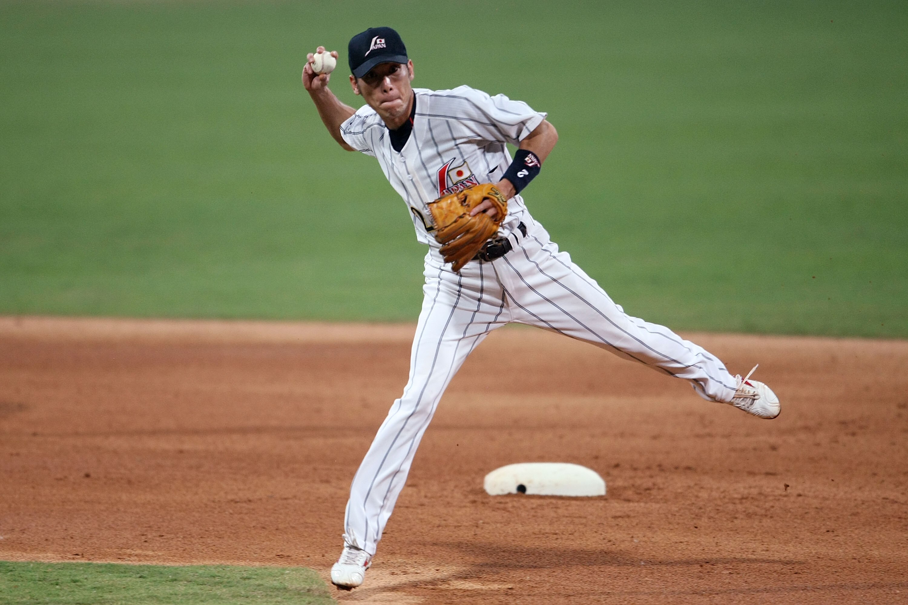 BEIJING - AUGUST 20:  Tsuyoshi Nishioka of Japan throws onto first for the putout against the United States in the baseball event at the Wukesong Baseball Field during Day 12 of the Beijing 2008 Olympic Games on August 20, 2008 in Beijing, China.  (Photo