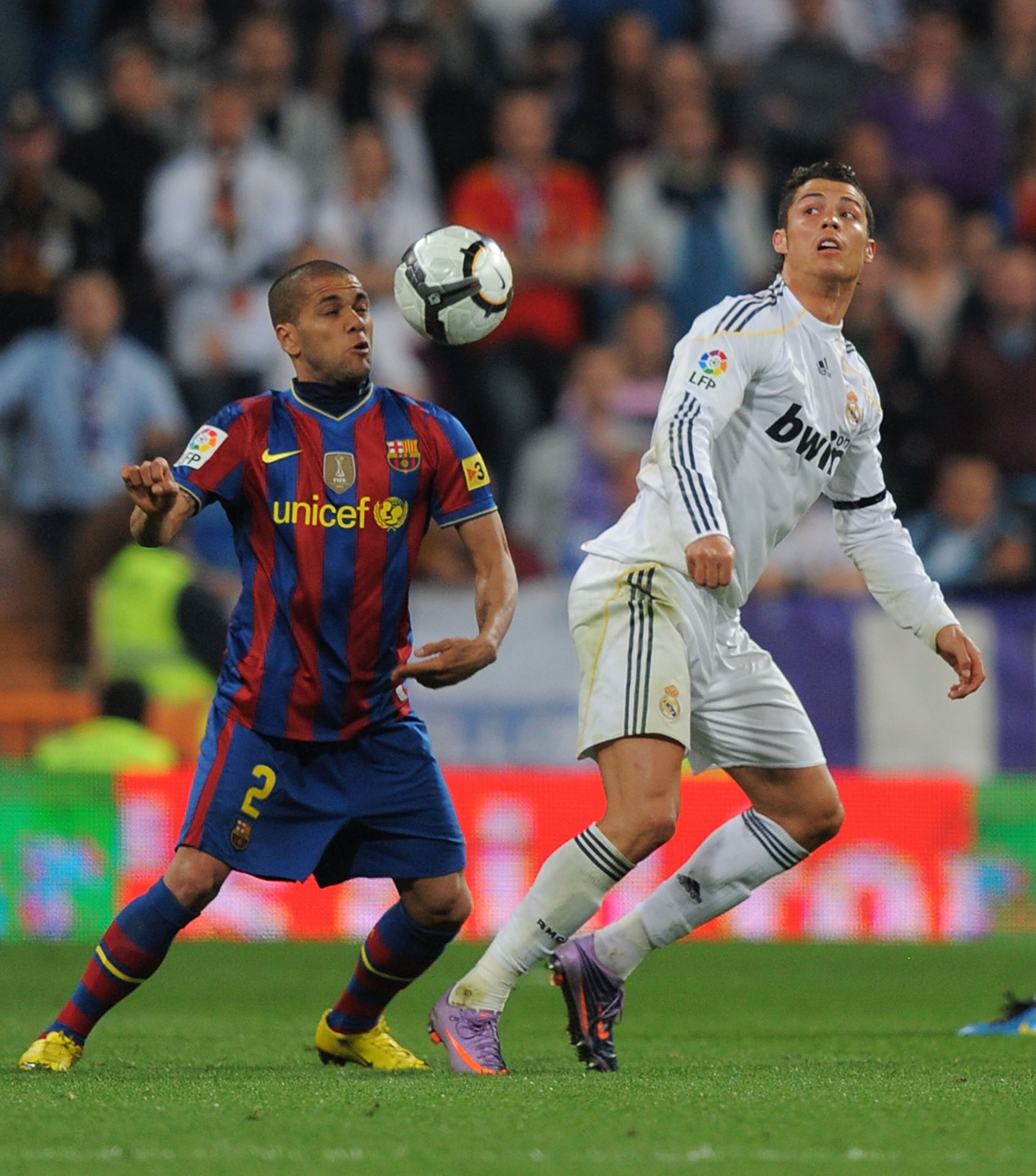MADRID, SPAIN - APRIL 10: Cristiano Ronaldo (R) of Real Madrid is tackled by Dani Alves of Barcelona during the La Liga match between Real Madrid and Barcelona at the Estadio Santiago Bernabeu on April 10, 2010 in Madrid, Spain.  (Photo by Denis Doyle/Get