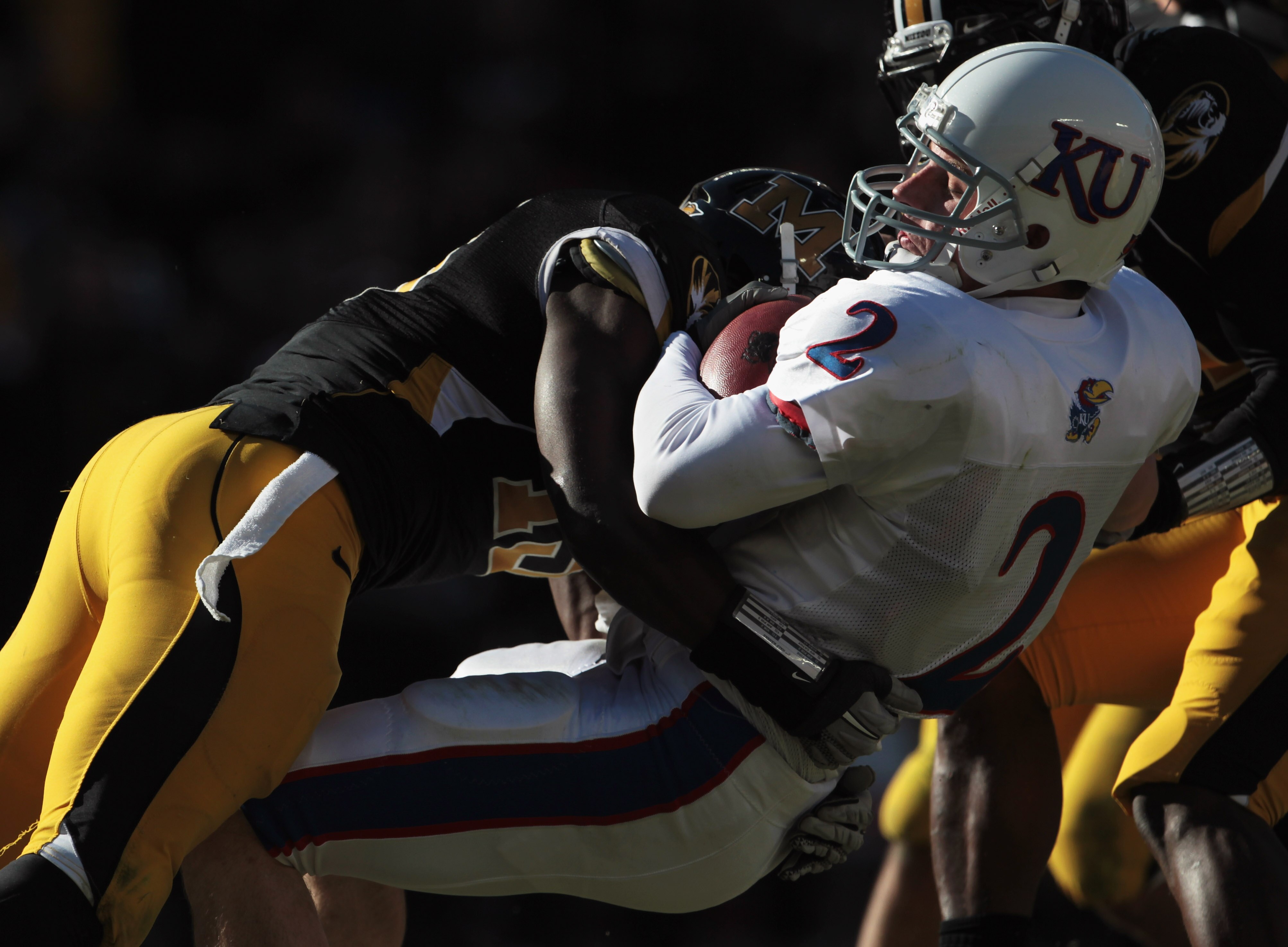 KANSAS CITY, MO - NOVEMBER 27:  Quarterback Jordan Webb #2 of the Kansas Jayhawks carries the ball into the endzone for a touchdown as Kenji Jackson #13 of the Missouri Tigers defends on November 27, 2010 at Arrowhead Stadium in Kansas City, Missouri.  (P