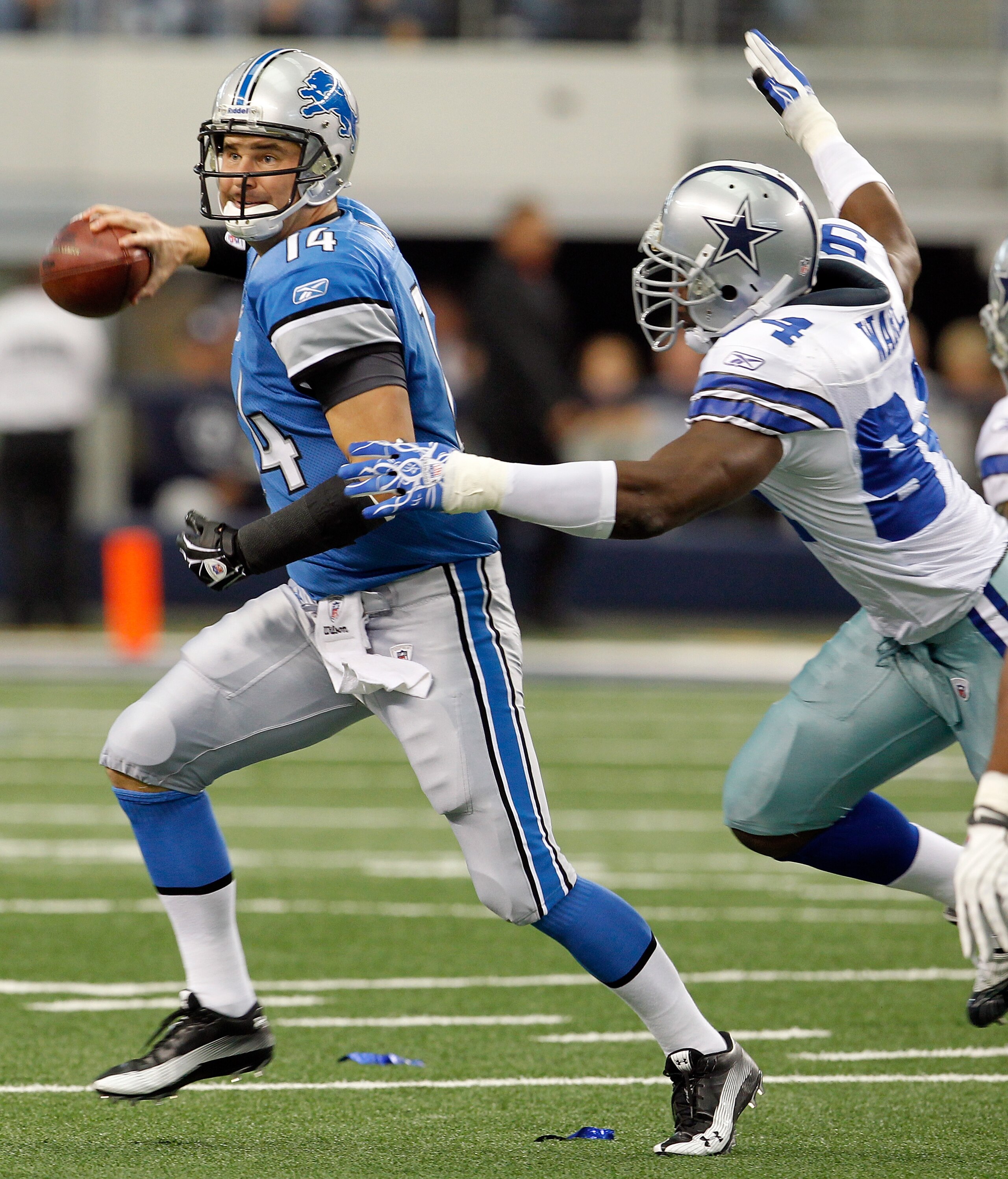 ARLINGTON, TX - NOVEMBER 21: Quarterback Shaun Hill #14 of the Detroit Lions scrambles with the ball under pressure by Demarcus Ware #94 of the Dallas Cowboys at Cowboys Stadium on November 21, 2010 in Arlington, Texas. The Cowboys beat the Lions 35-19. ARLINGTON, TX - NOVEMBER 21: Quarterback Shaun Hill #14 of the Detroit Lions scrambles with the ball under pressure by Demarcus Ware #94 of the Dallas Cowboys at Cowboys Stadium on November 21, 2010 in Arlington, Texas. The Cowboys beat the Lions 35-19.