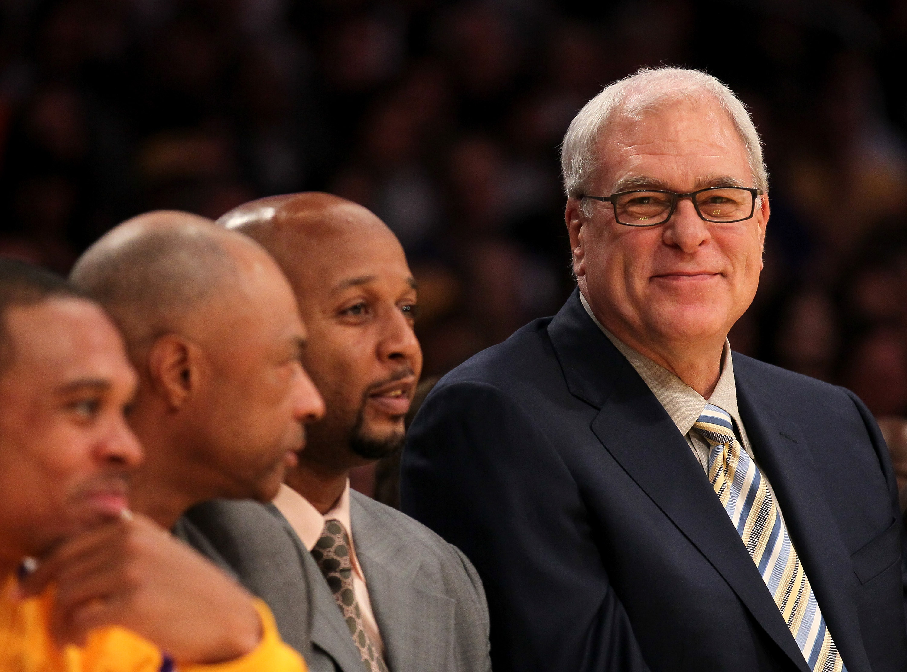 LOS ANGELES, CA - NOVEMBER 05:  Head coach Phil Jackson (L) of the Los Angeles Lakers smiles on the bench next to assistants Brian Shaw (C) and Jim Cleamons during the game with the Toronto Raptors at Staples Center on November 5, 2010 in Los Angeles, Cal