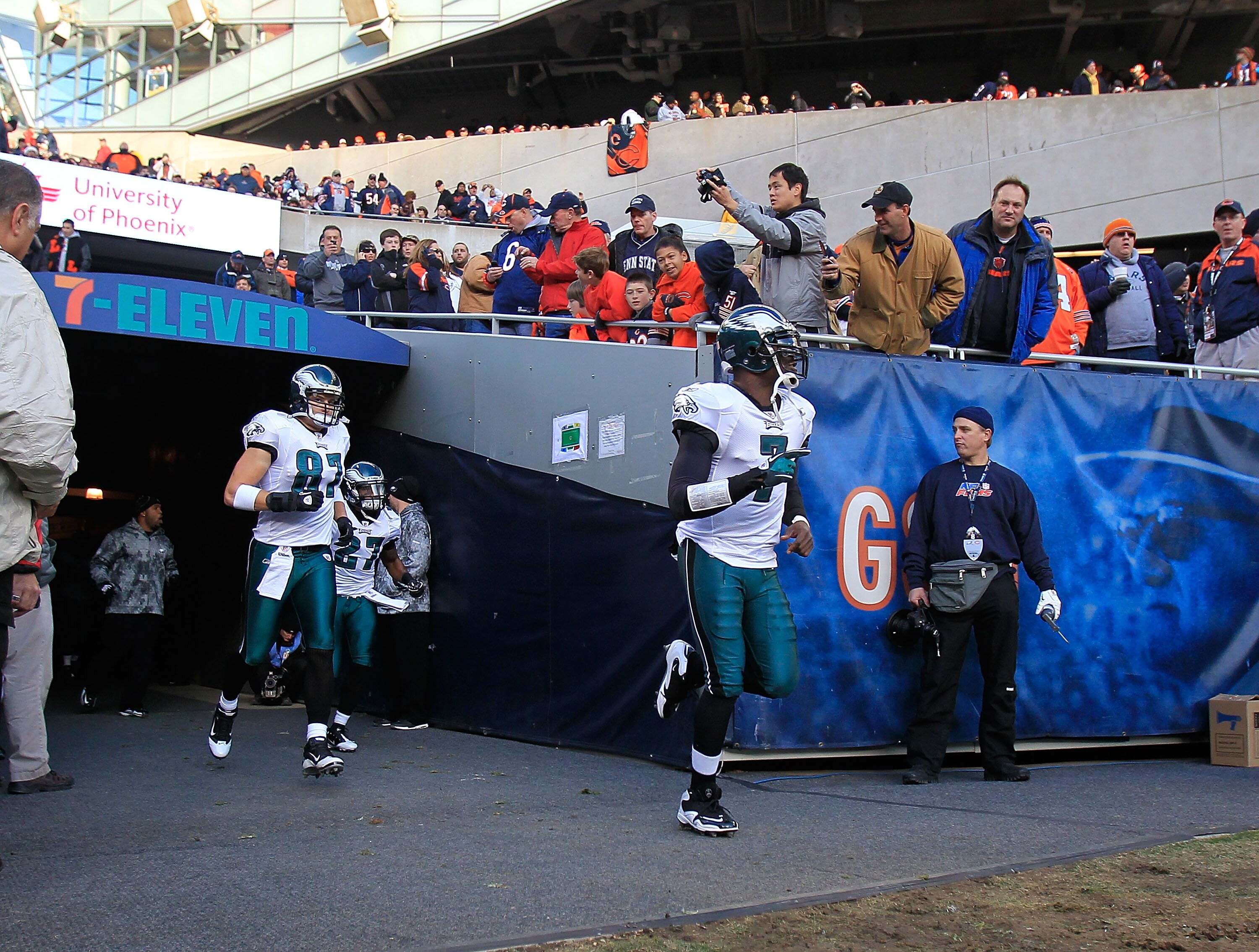 CHICAGO - NOVEMBER 28: Michael Vick #7, Brent Celek #87 and Quintin Mikell #27 of the Philadelphia Eagles run onto the field before a game against the Chicago Bears at Soldier Field on November 28, 2010 in Chicago, Illinois. The Bears defeated the Eagles 