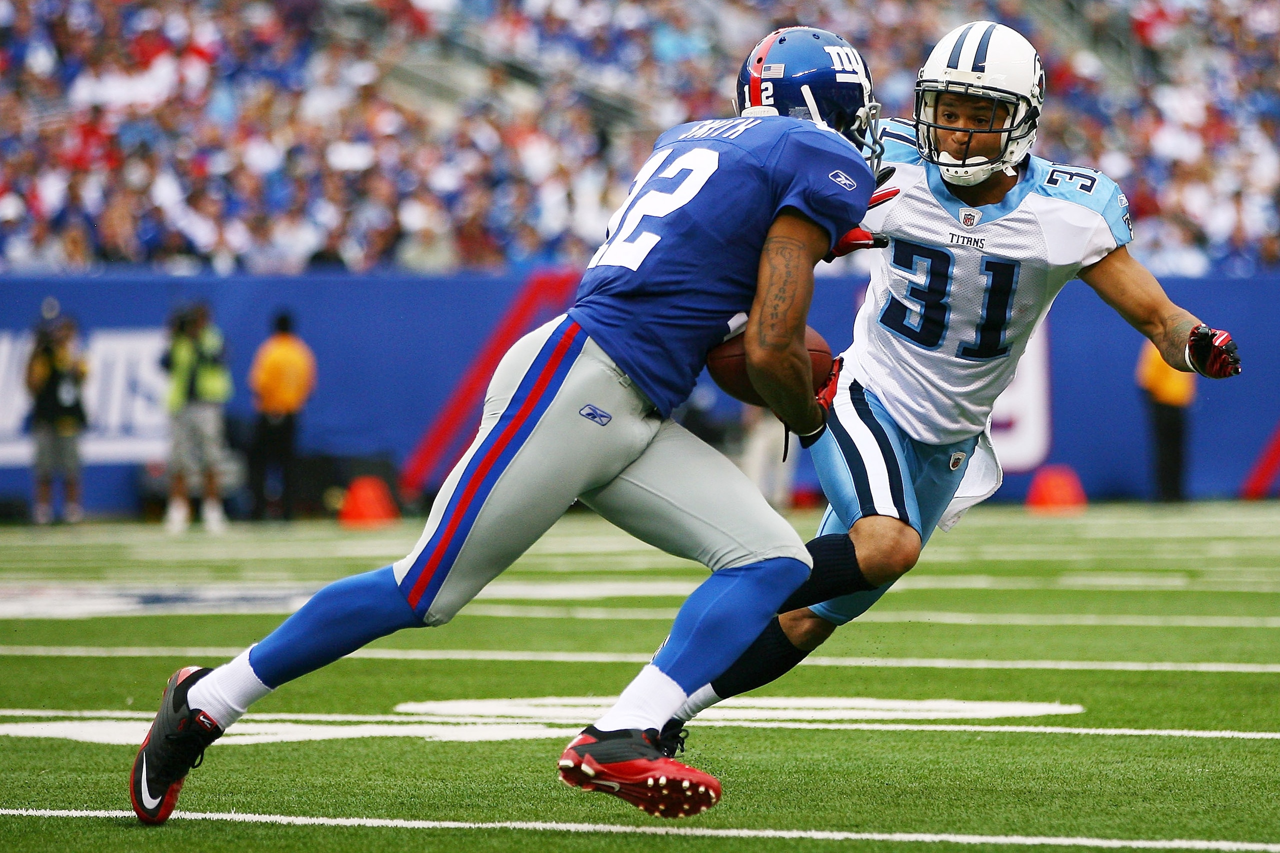 EAST RUTHERFORD, NJ - SEPTEMBER 26: Steve Smith #12 of the New York Giants runs the ball against Cortland Finnegan #31 of the Tennessee Titans at New Meadowlands Stadium on September 26, 2010 in East Rutherford, New Jersey. The Titans defeated the Giants EAST RUTHERFORD, NJ - SEPTEMBER 26: Steve Smith #12 of the New York Giants runs the ball against Cortland Finnegan #31 of the Tennessee Titans at New Meadowlands Stadium on September 26, 2010 in East Rutherford, New Jersey. The Titans defeated the Giants