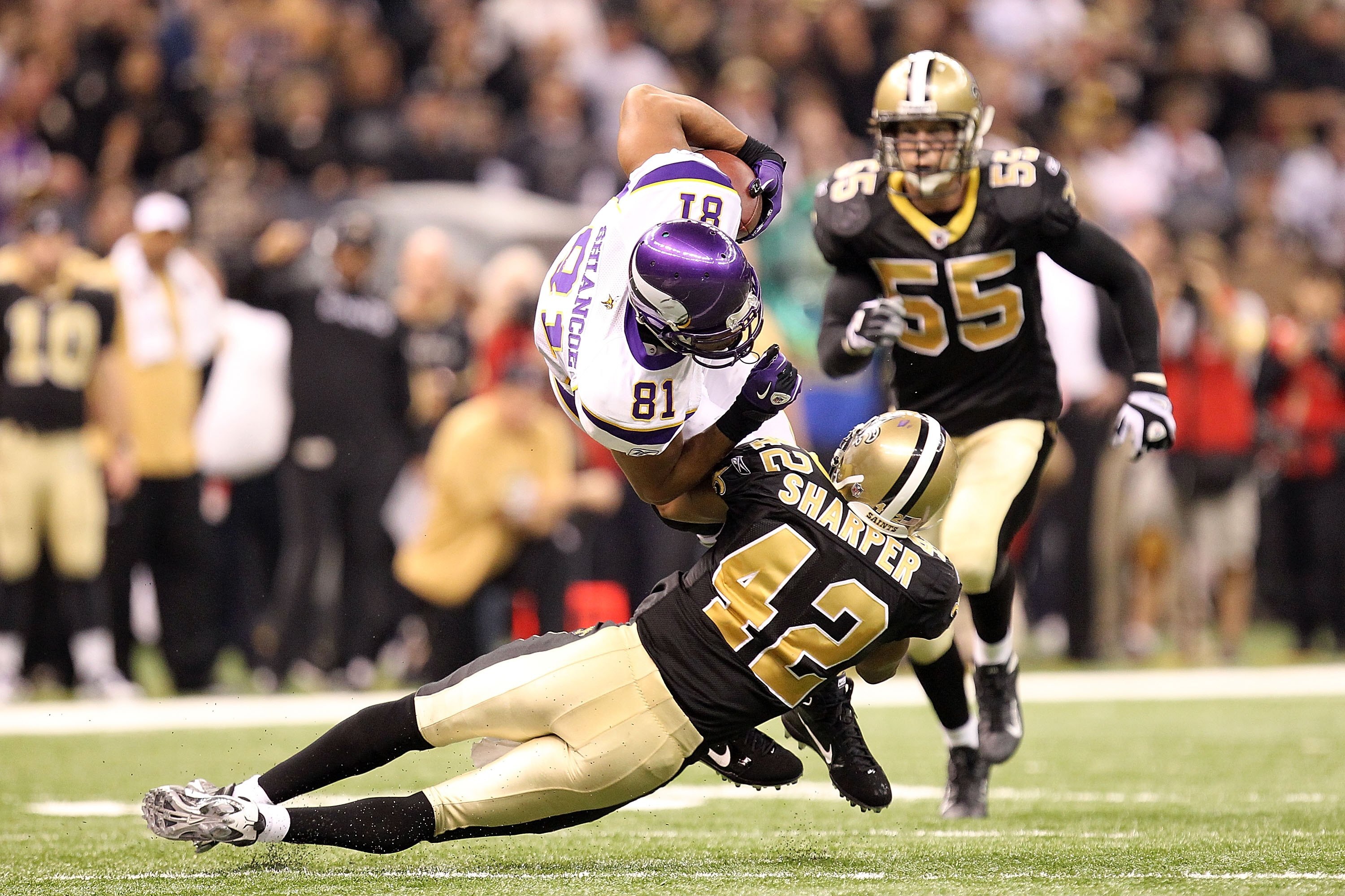 NEW ORLEANS - JANUARY 24:  Visanthe Shiancoe of #81 the Minnesota Vikings is tackled on a reception by Darren Sharper #42 of the New Orleans Saints during the NFC Championship Game at the Louisiana Superdome on January 24, 2010 in New Orleans, Louisiana.