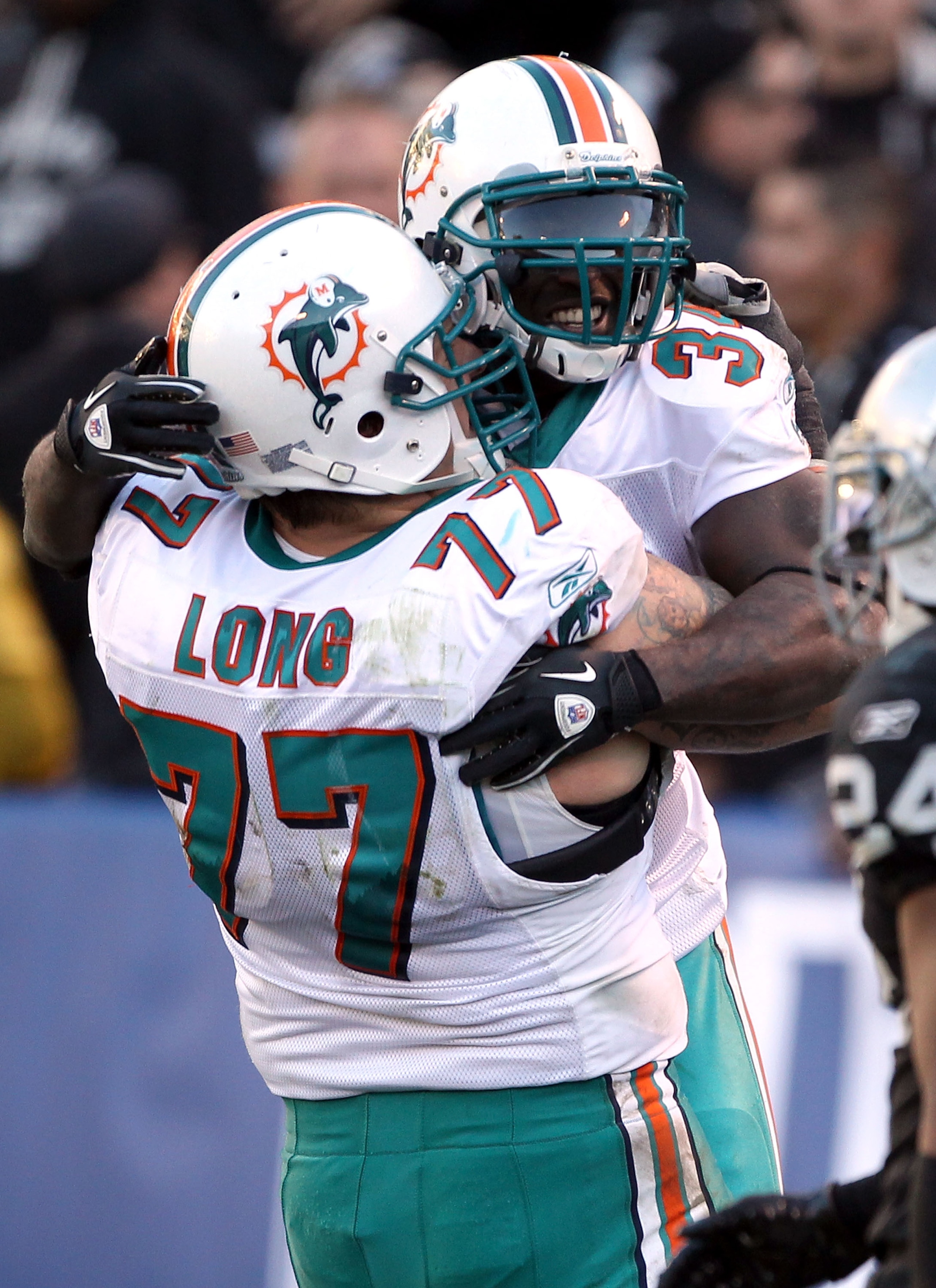 OAKLAND, CA - NOVEMBER 28: Ricky Williams #34 of the Miami Dolphins celebrates with Jake Long #77 after Williams scored a touchdown during their game against the Oakland Raiders at Oakland-Alameda County Coliseum on November 28, 2010 in Oakland, Californ OAKLAND, CA - NOVEMBER 28: Ricky Williams #34 of the Miami Dolphins celebrates with Jake Long #77 after Williams scored a touchdown during their game against the Oakland Raiders at Oakland-Alameda County Coliseum on November 28, 2010 in Oakland, Californ
