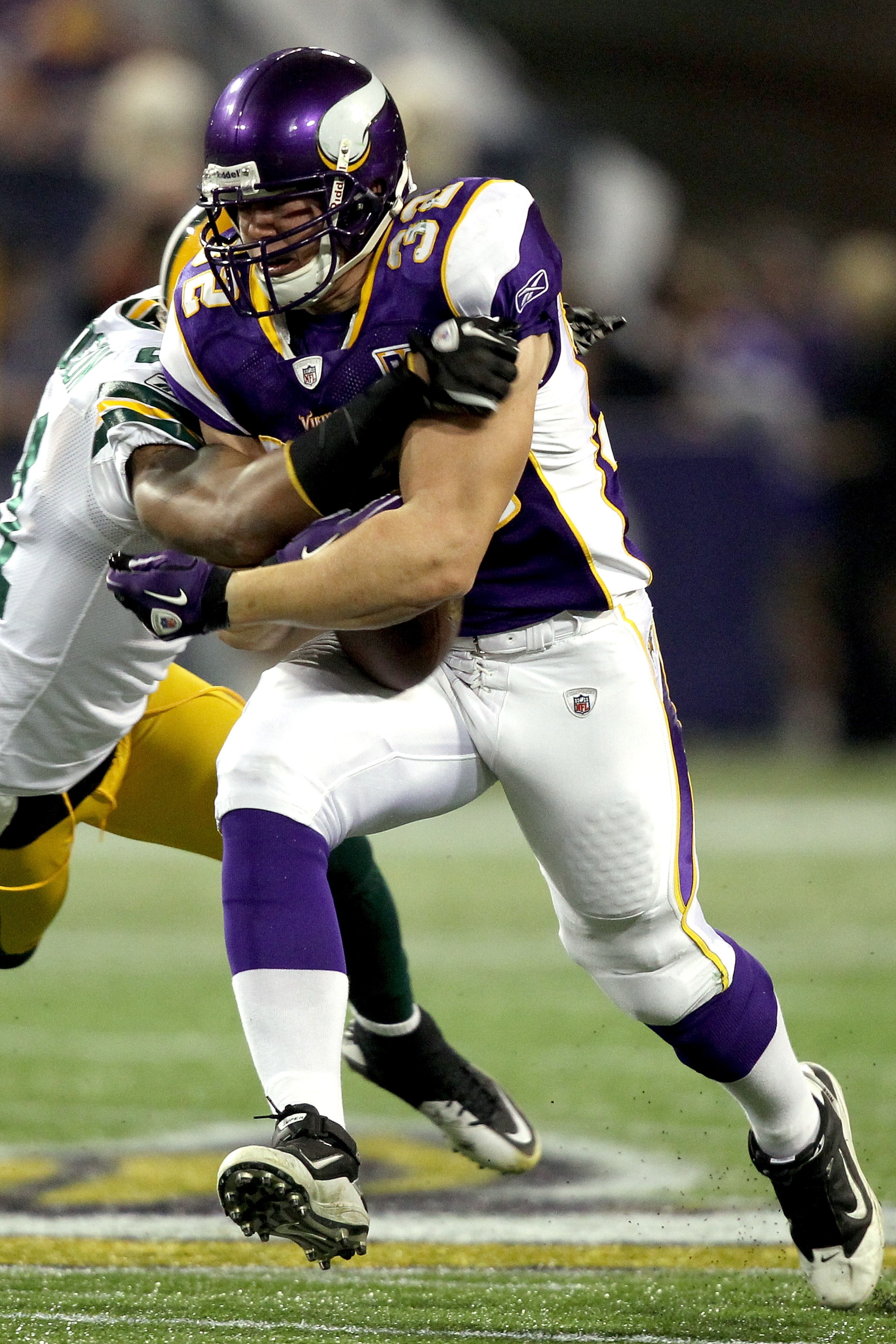 MINNEAPOLIS - NOVEMBER 21:  Toby Gerhart #32 of the Minnesota Vikings has the ball jarred loose by Charles Woodson #21 of the Green Bay Packers at the Hubert H. Humphrey Metrodome on November 21, 2010 in Minneapolis, Minnesota.  (Photo by Matthew Stockman