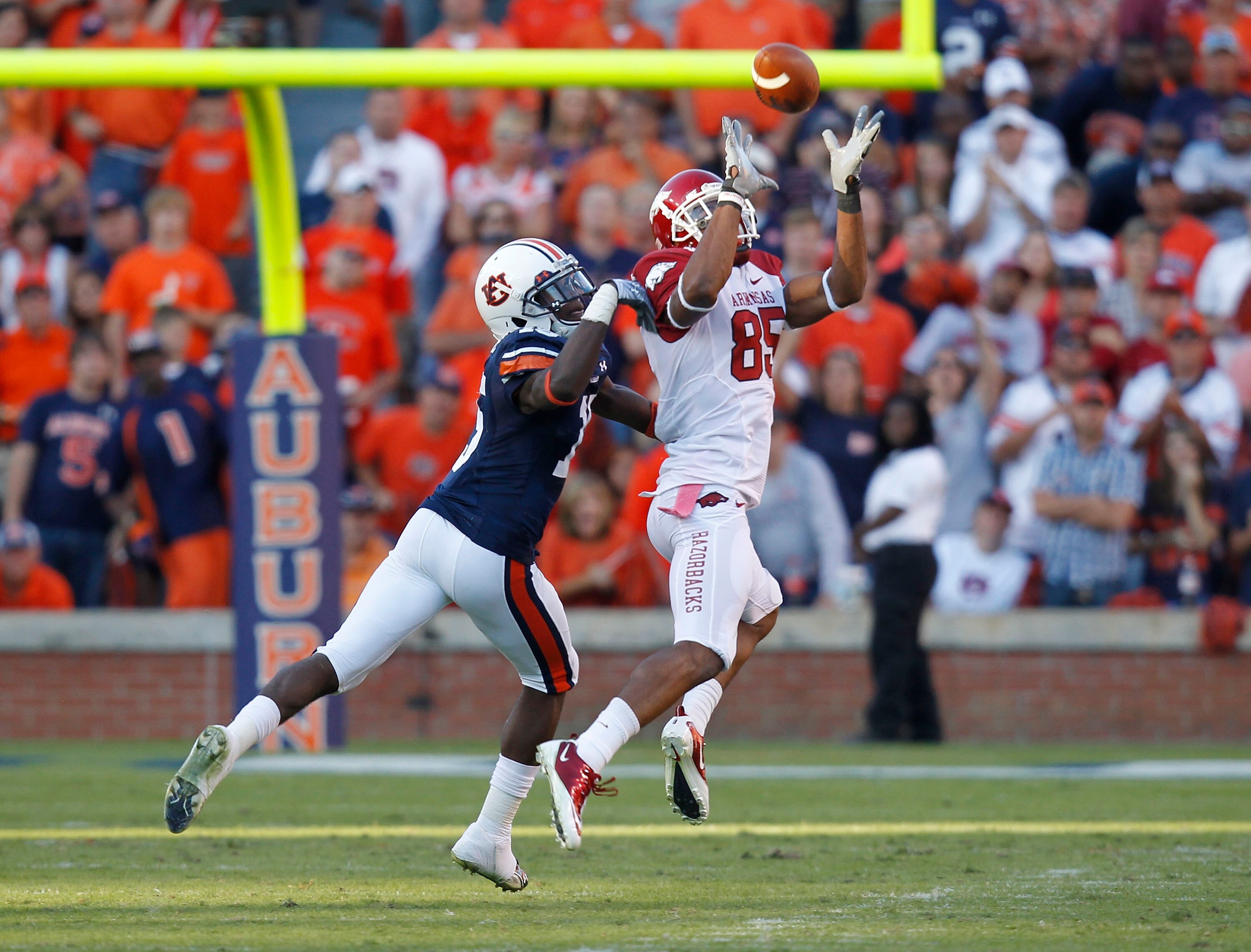 AUBURN - OCTOBER 16:  Wide receiver Greg Childs #85 of the Arkansas Razorbacks catches a pass behind defensive back Neiko Thorpe #15 of the Auburn Tigers during the game at Jordan-Hare Stadium on October 16, 2010 in Auburn, Alabama.  The Tigers beat the R