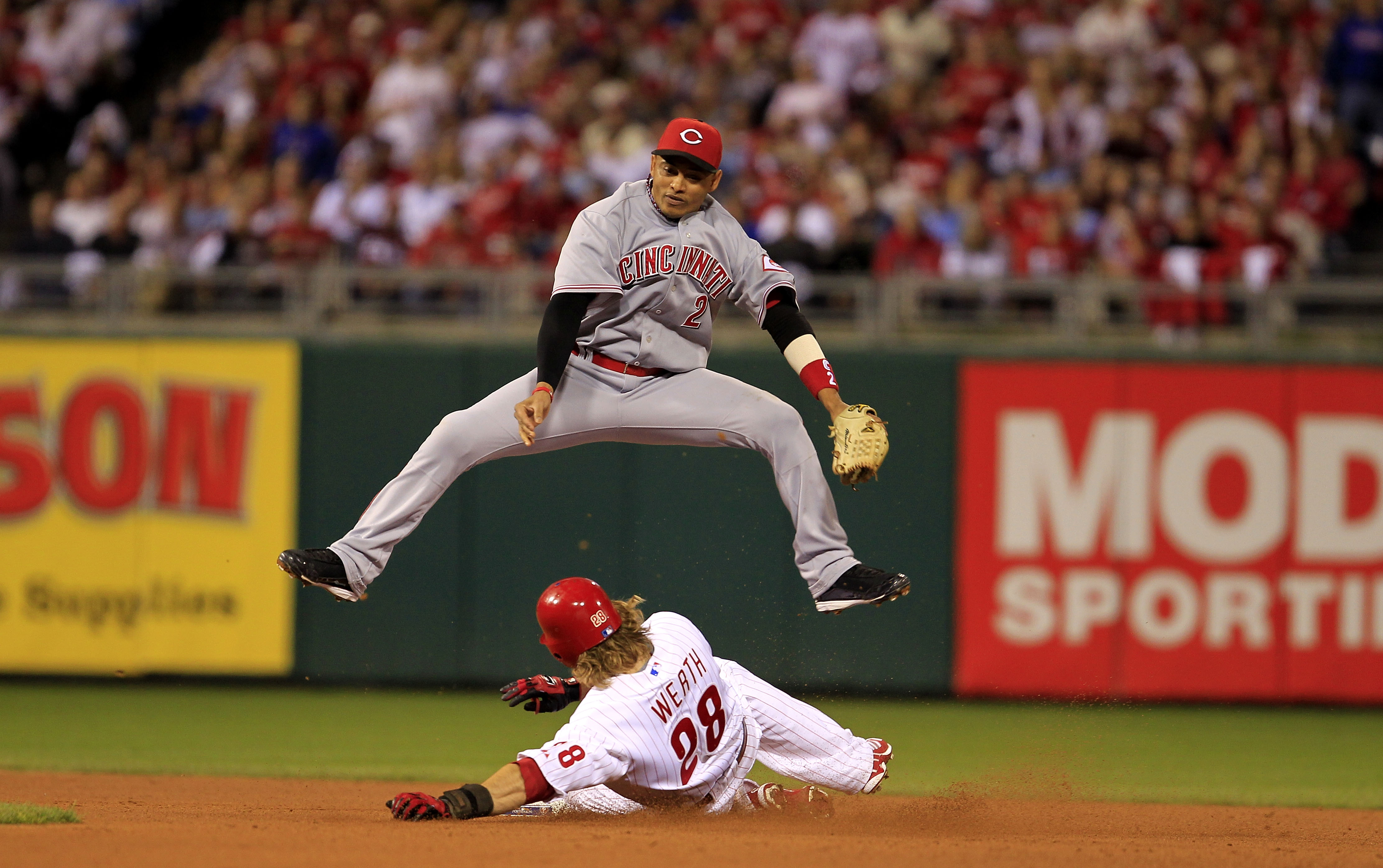 PHILADELPHIA - OCTOBER 08: Orlando Cabrera #2 of the Cincinnati Reds leaps over Jayson Werth #28 of the Philadelphia Phillies as Werth steals second base during game 2 of the NLDS at Citizens Bank Park on October 8, 2010 in Philadelphia, Pennsylvania. Th PHILADELPHIA - OCTOBER 08: Orlando Cabrera #2 of the Cincinnati Reds leaps over Jayson Werth #28 of the Philadelphia Phillies as Werth steals second base during game 2 of the NLDS at Citizens Bank Park on October 8, 2010 in Philadelphia, Pennsylvania. Th