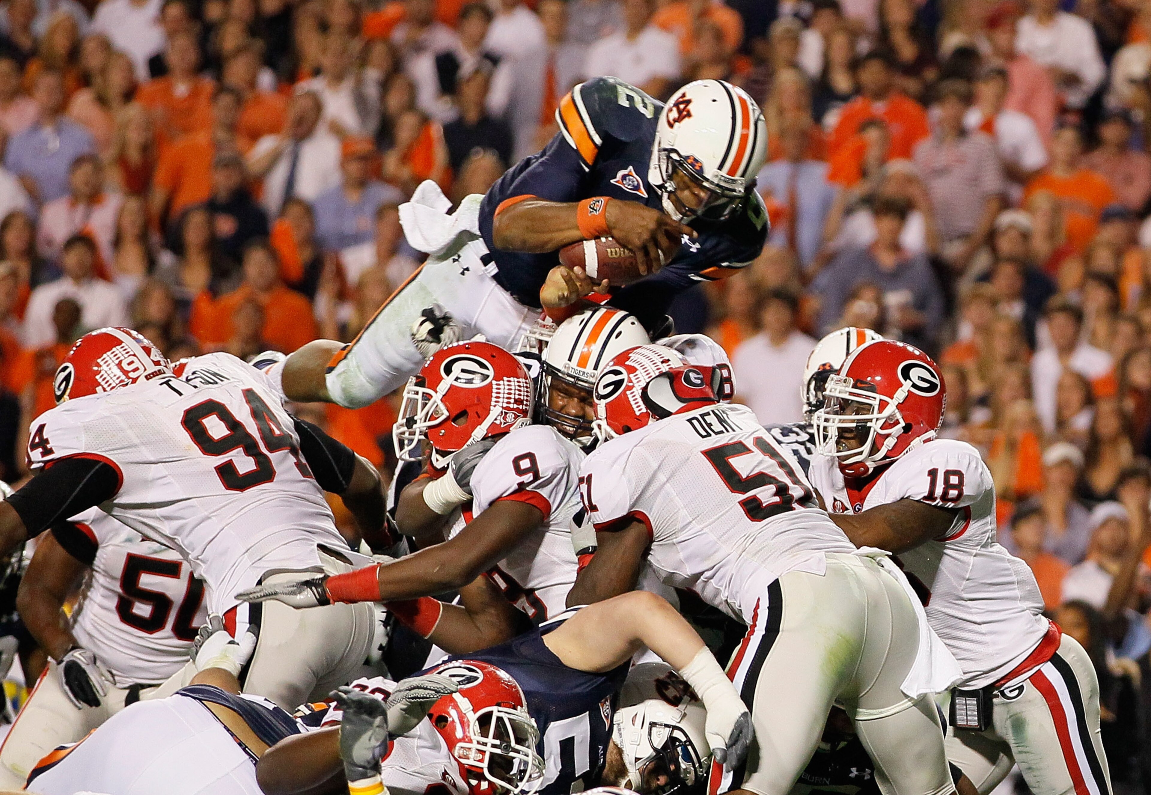 AUBURN, AL - NOVEMBER 13: Quarterback Cameron Newton #2 of the Auburn Tigers dives across the defense for a touchdown against the Georgia Bulldogs at Jordan-Hare Stadium on November 13, 2010 in Auburn, Alabama. (Photo by Kevin C. Cox/Getty Images) AUBURN, AL - NOVEMBER 13: Quarterback Cameron Newton #2 of the Auburn Tigers dives across the defense for a touchdown against the Georgia Bulldogs at Jordan-Hare Stadium on November 13, 2010 in Auburn, Alabama. (Photo by Kevin C. Cox/Getty Images)