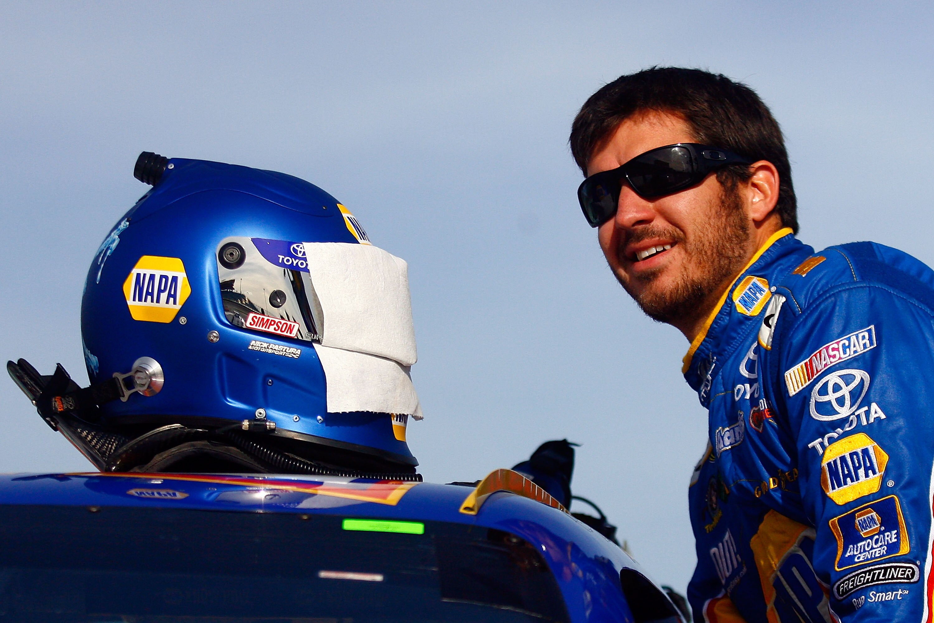 HOMESTEAD, FL - NOVEMBER 19:  Martin Truex Jr., driver of the #56 NAPA Toyota, climbs in his car during qualifying for the NASCAR Sprint Cup Series Ford 400 at Homestead-Miami Speedway on November 19, 2010 in Homestead, Florida.  (Photo by Jason Smith/Get