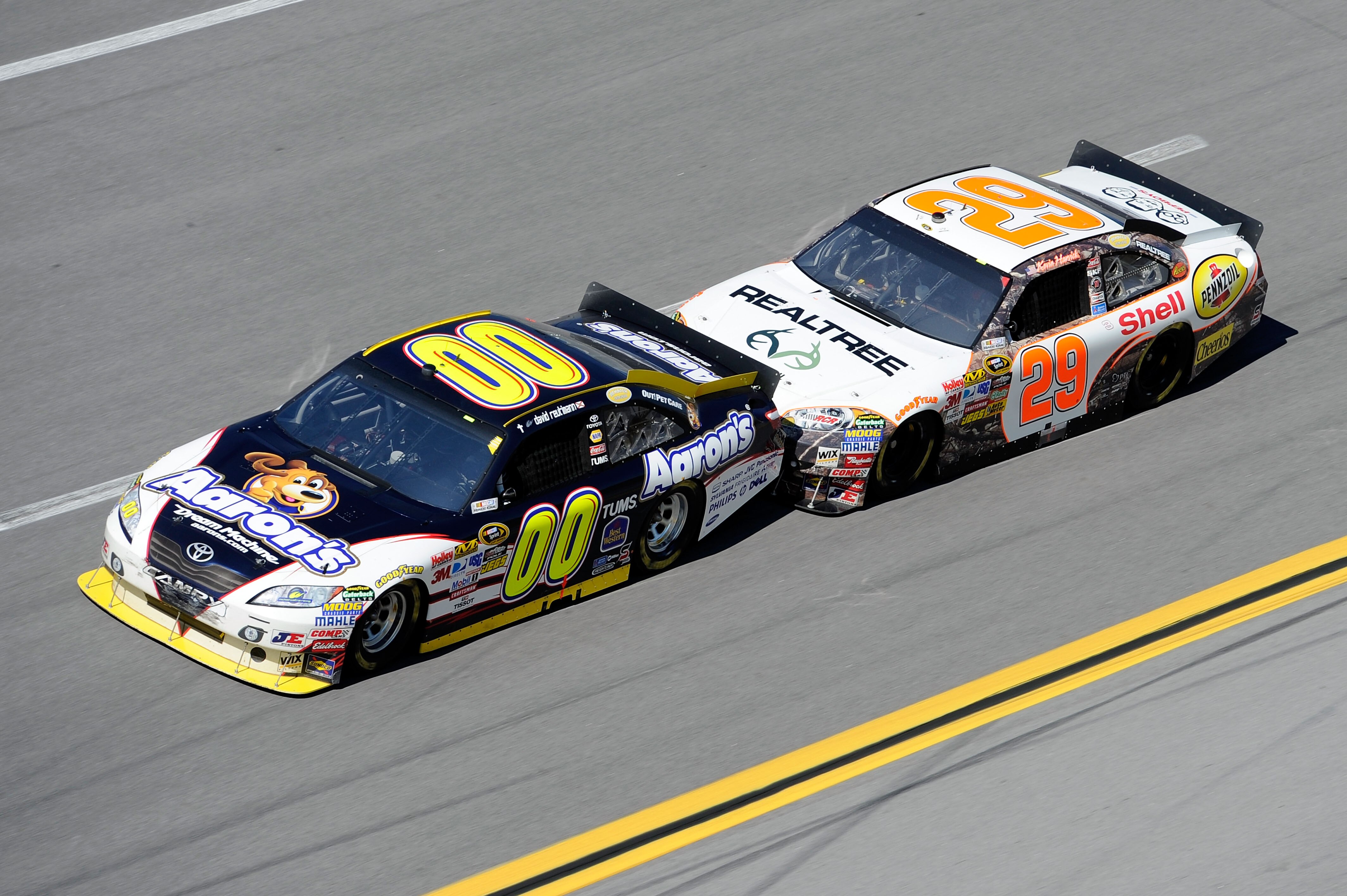TALLADEGA, AL - OCTOBER 31:   David Reutimann, driver of the #00 Aaron's Dream Machine Toyota,  leads Kevin Harvick, driver of the #29 Realtree/Shell/Pennzoil Chevrolet, during the NASCAR Sprint Cup Series AMP Energy Juice 500 at Talladega Superspeedway o