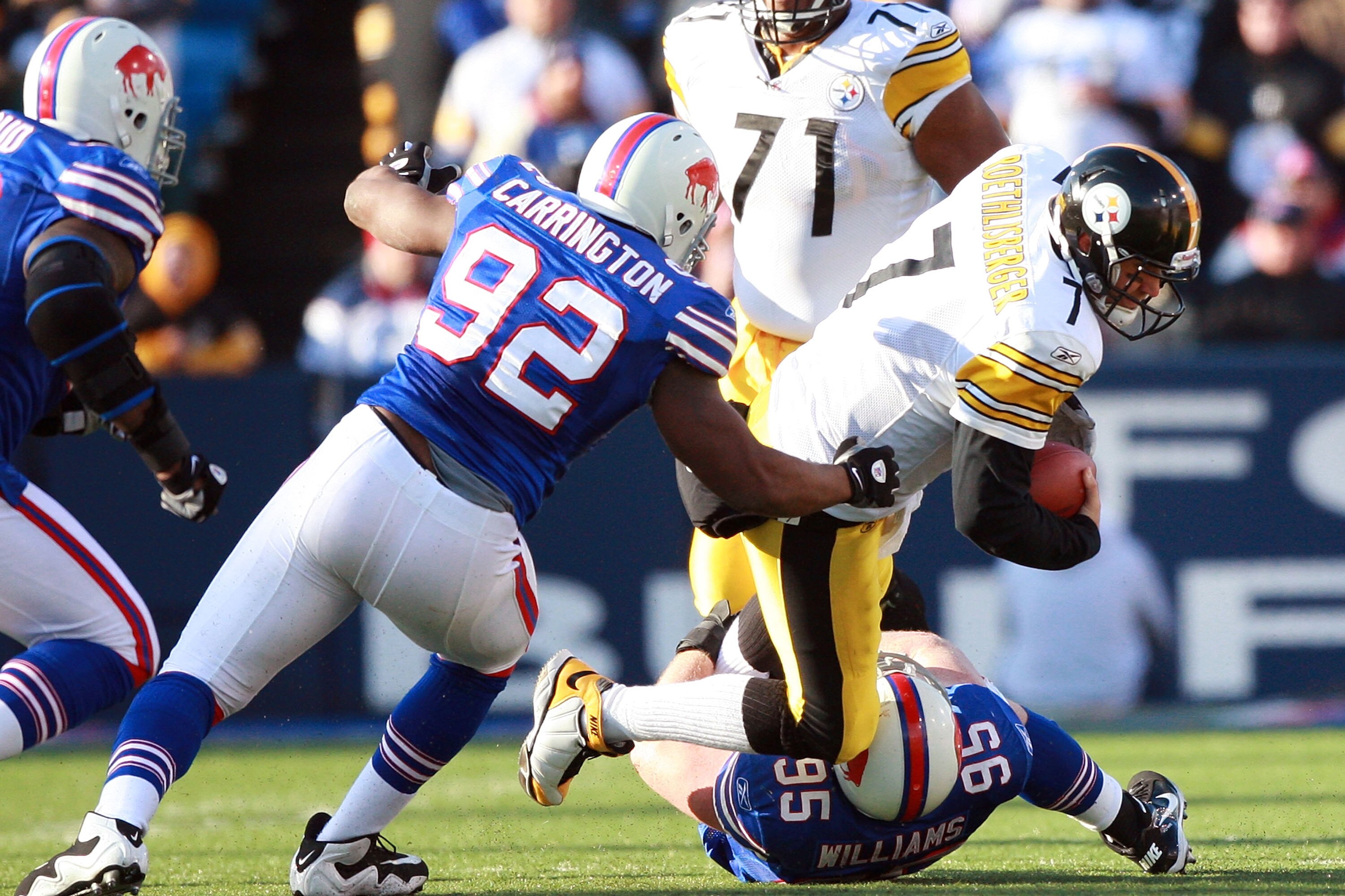 ORCHARD PARK, NY - NOVEMBER 28:  Ben Roethlisberger #7 of the Pittsburgh Steelers is sacked by Alex Carrington #92 and Kyle Williams #95 of the Buffalo Bills at Ralph Wilson Stadium on November 28, 2010 in Orchard Park, New York.  (Photo by Karl Walter/Ge