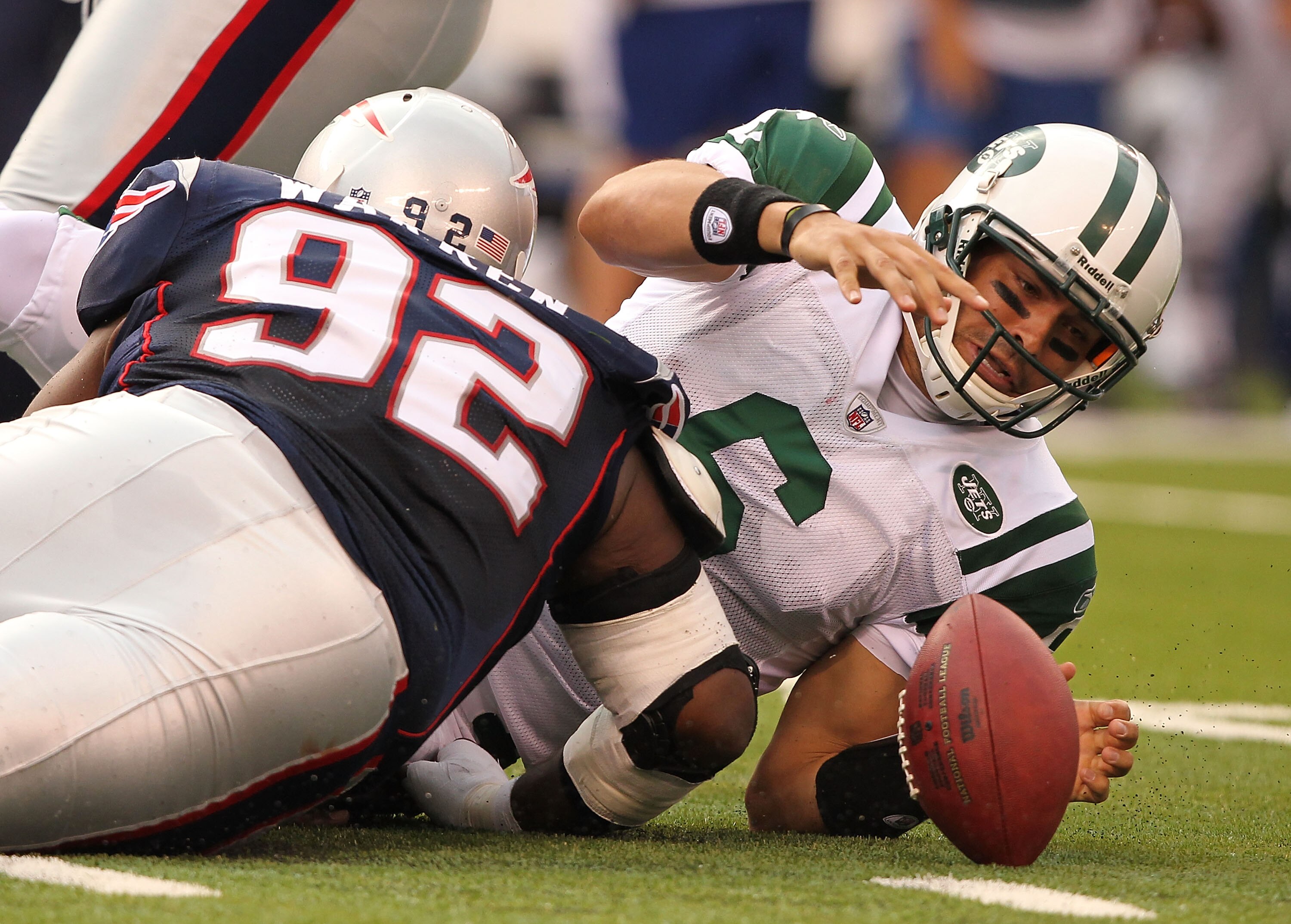 EAST RUTHERFORD, NJ - SEPTEMBER 19:  Mark Sanchez #6  of the New York Jets fumbles the ball after being sacked by Gerard Warren #92 of the New England Patriots during their  game on September 19, 2010 at the New Meadowlands Stadium  in East Rutherford, Ne