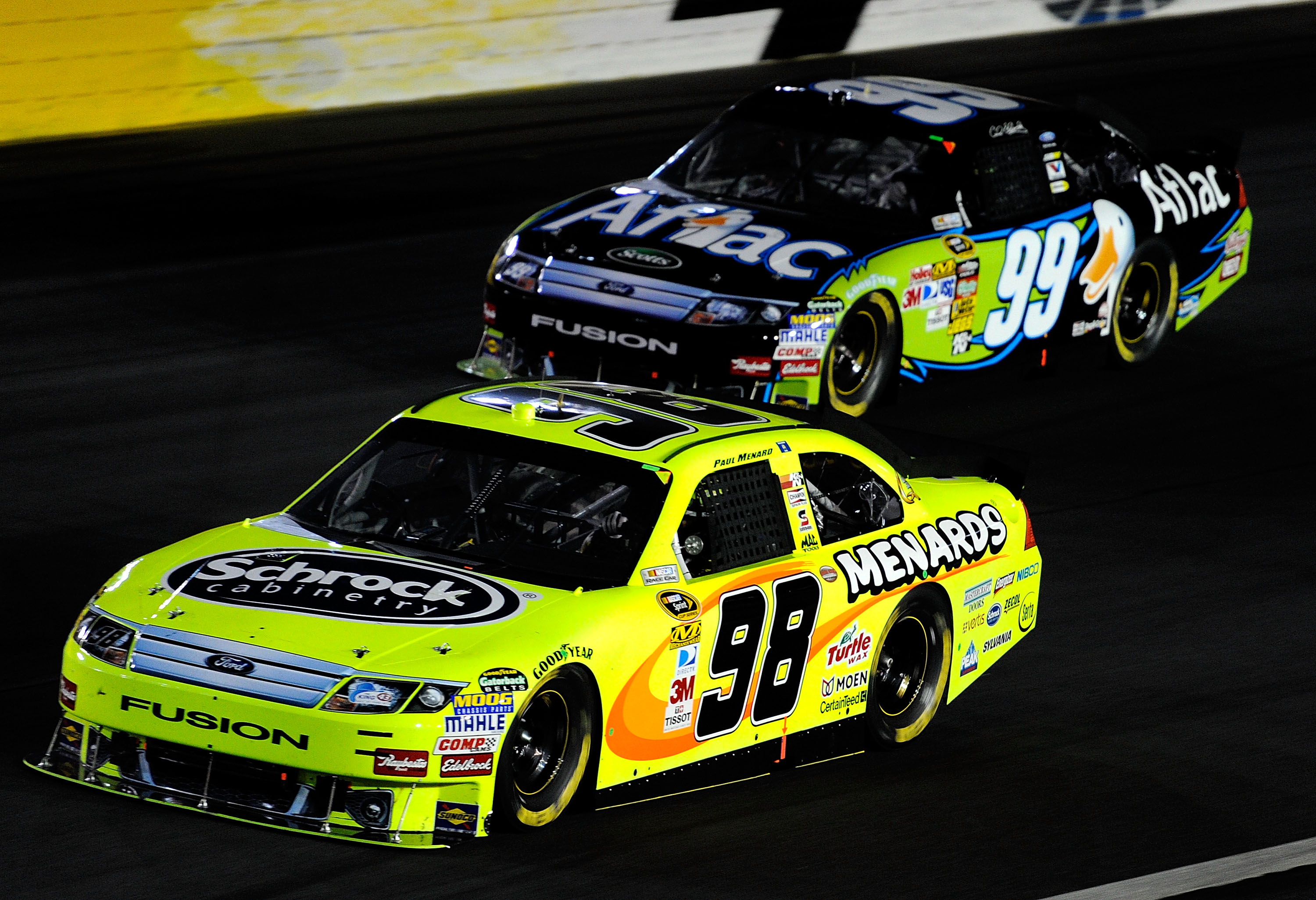 CONCORD, NC - OCTOBER 16:  Paul Menard, driver of the #98 Schrock/Menards Ford, races Carl Edwards, driver of the #99 Aflac Ford, during the NASCAR Sprint Cup Series Bank of America 500 at Charlotte Motor Speedway on October 16, 2010 in Concord, North Car