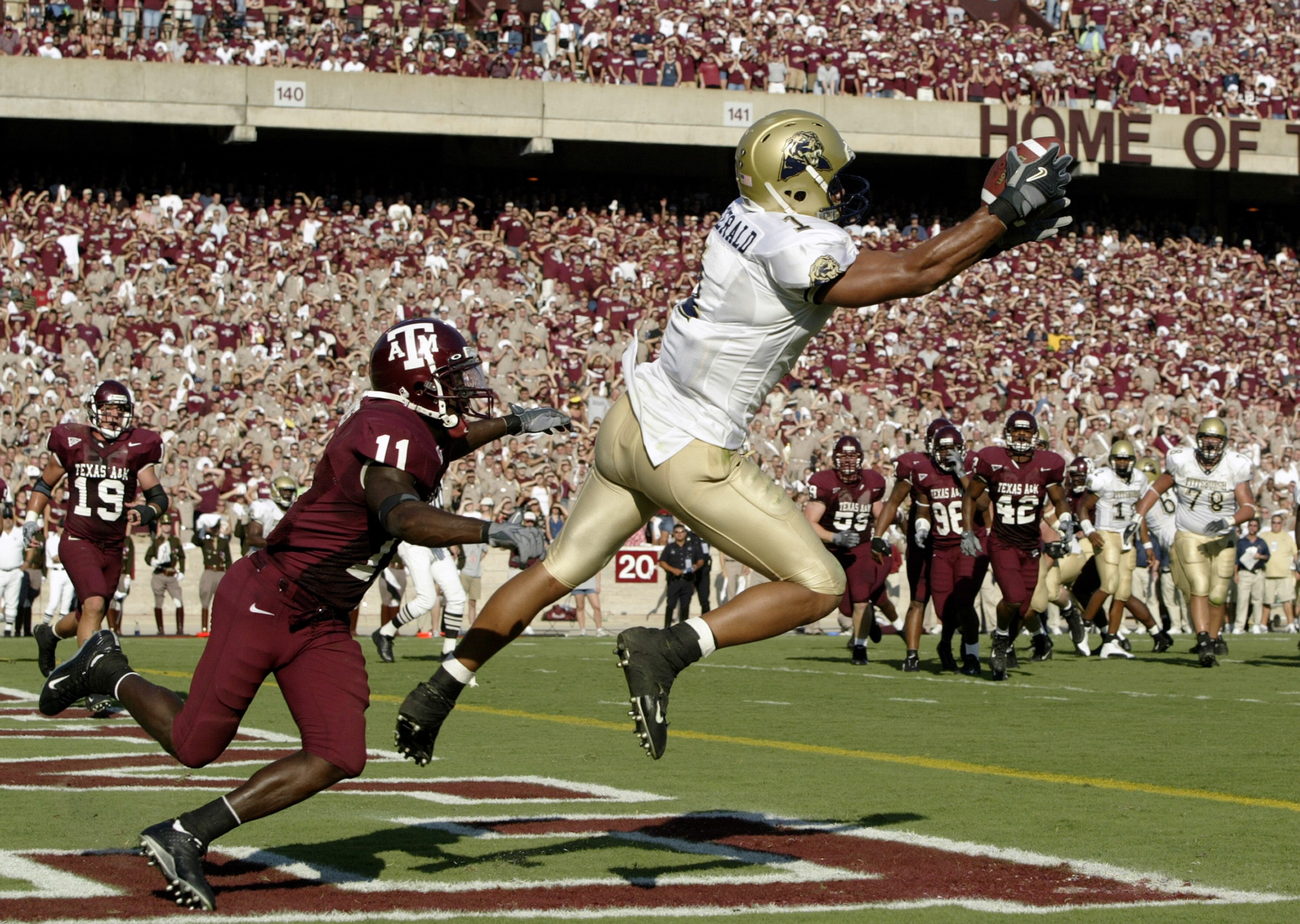 COLLEGE STATION, TX - SEPTEMBER 27:  Wide receiver Larry Fitzgerald #1 of the University of Pittsburgh Panthers pulls in a touchdown pass against the Texas A&M University Aggies at Kyle Field on September 27, 2003 in College Station, Texas. Pittsburgh def