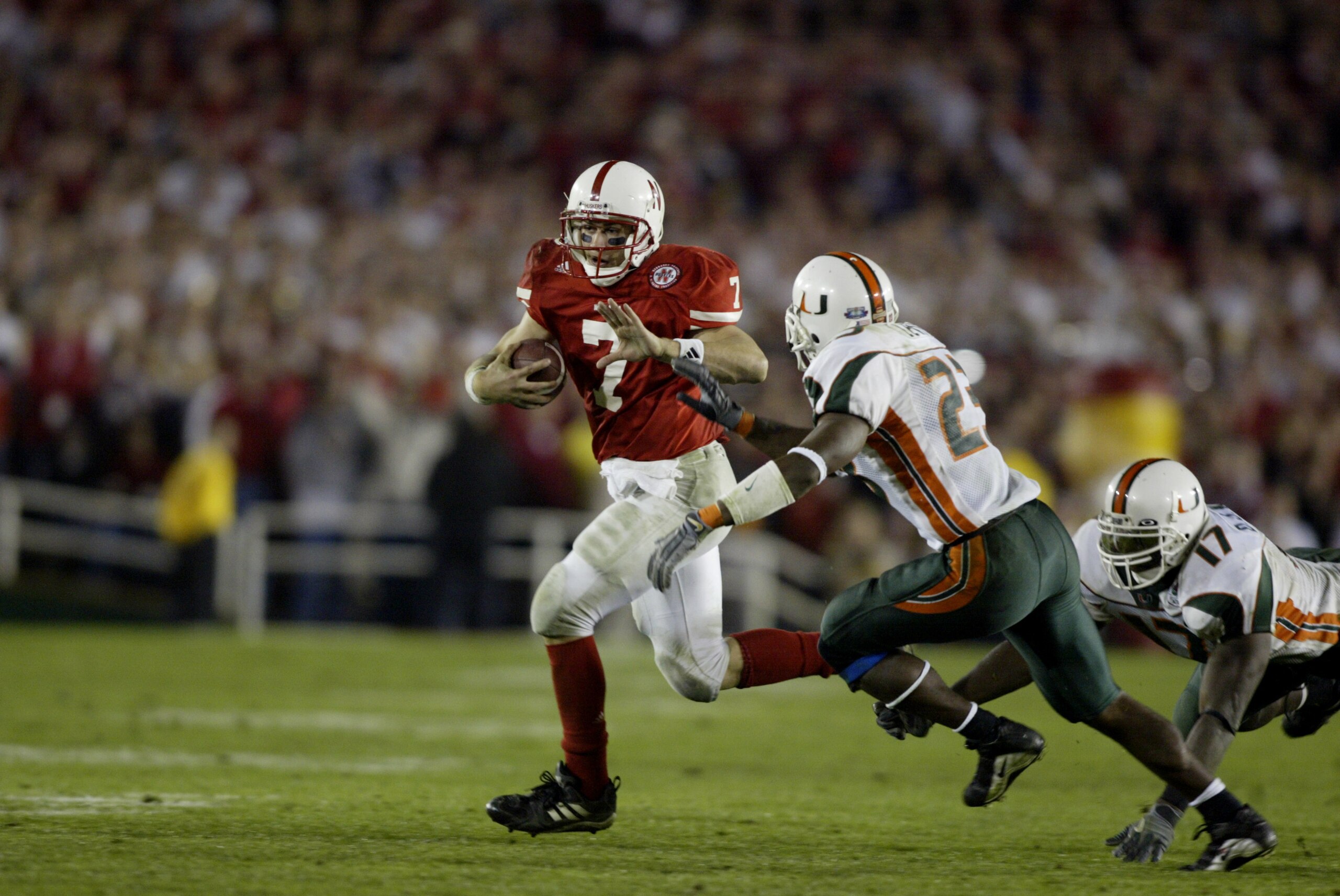 3 Jan 2002: Quarterback Eric Crouch #7 of Nebraska scrambles against the defense of James Lewis #23 of Miami during the Rose Bowl National Championship game at the Rose Bowl in Pasadena, California. Miami won the game 37-14, winning the BCS and the Nati 3 Jan 2002: Quarterback Eric Crouch #7 of Nebraska scrambles against the defense of James Lewis #23 of Miami during the Rose Bowl National Championship game at the Rose Bowl in Pasadena, California. Miami won the game 37-14, winning the BCS and the Nati