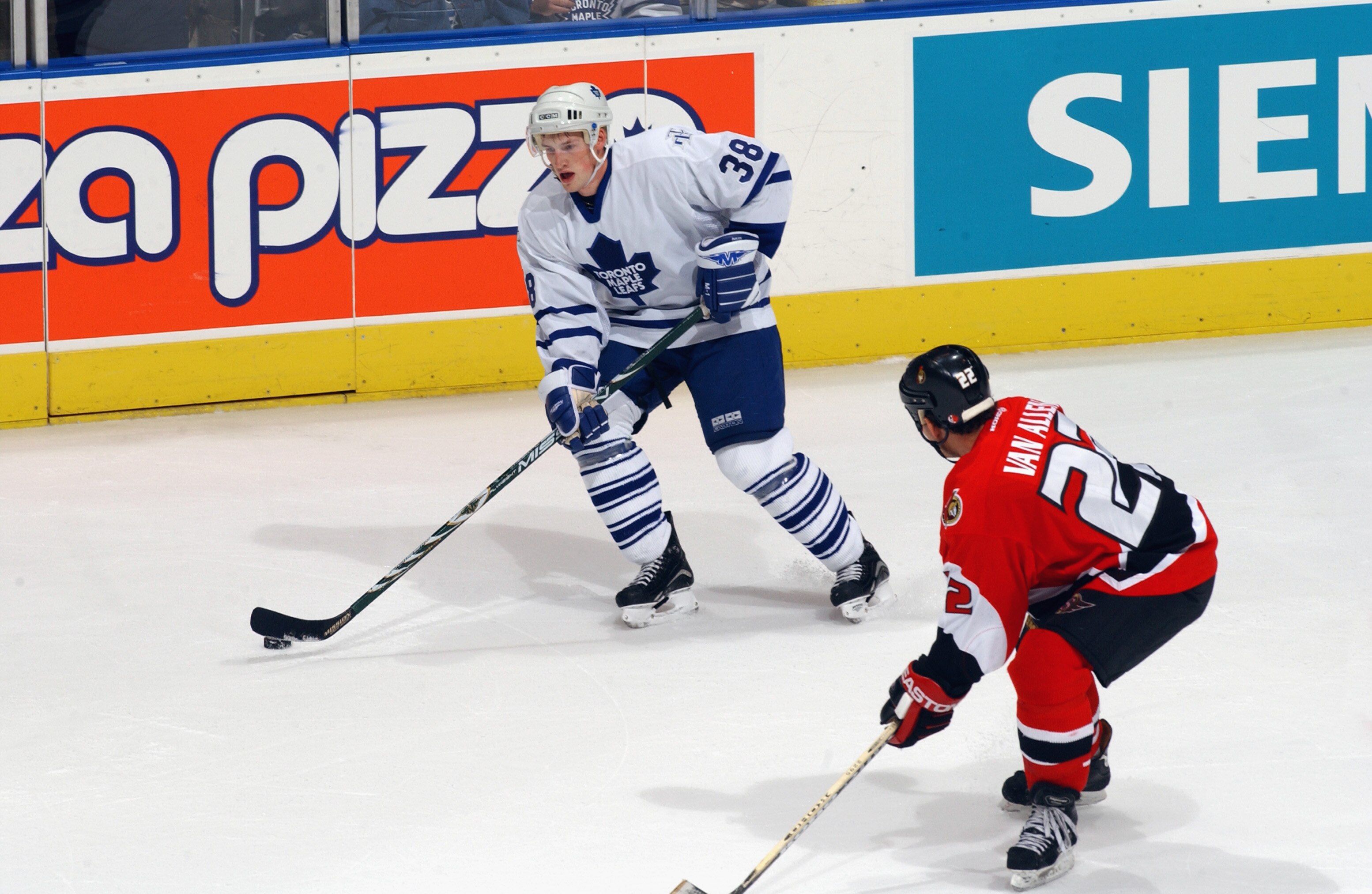 TORONTO - SEPTEMBER 22:  Forward Brad Boyes #38 of the Toronto Maple Leafs skates with the puck while being pressured by Shaun Van Allen #22 of the Ottawa Senators during the NHL pre-season game on September 22, 2002 at Air Canada Centre in Toronto, Ontar