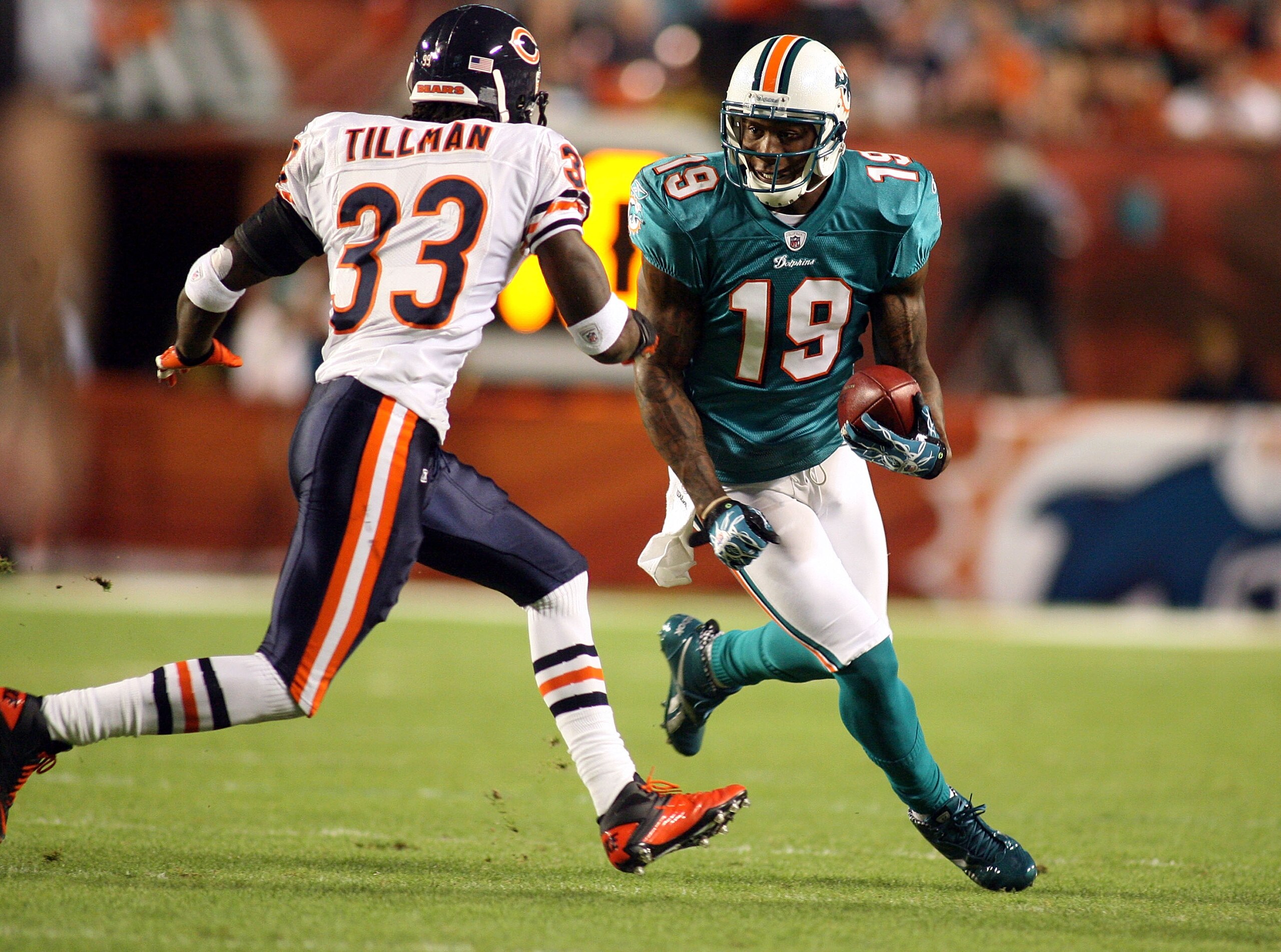 MIAMI - NOVEMBER 18: Receiver Brandon Marshall #19 of the Miami Dolphins runs as safety Charles Tillman #33 of the Chicago Bears defends at Sun Life Stadium on November 18, 2010 in Miami, Florida. (Photo by Marc Serota/Getty Images) MIAMI - NOVEMBER 18: Receiver Brandon Marshall #19 of the Miami Dolphins runs as safety Charles Tillman #33 of the Chicago Bears defends at Sun Life Stadium on November 18, 2010 in Miami, Florida. (Photo by Marc Serota/Getty Images)