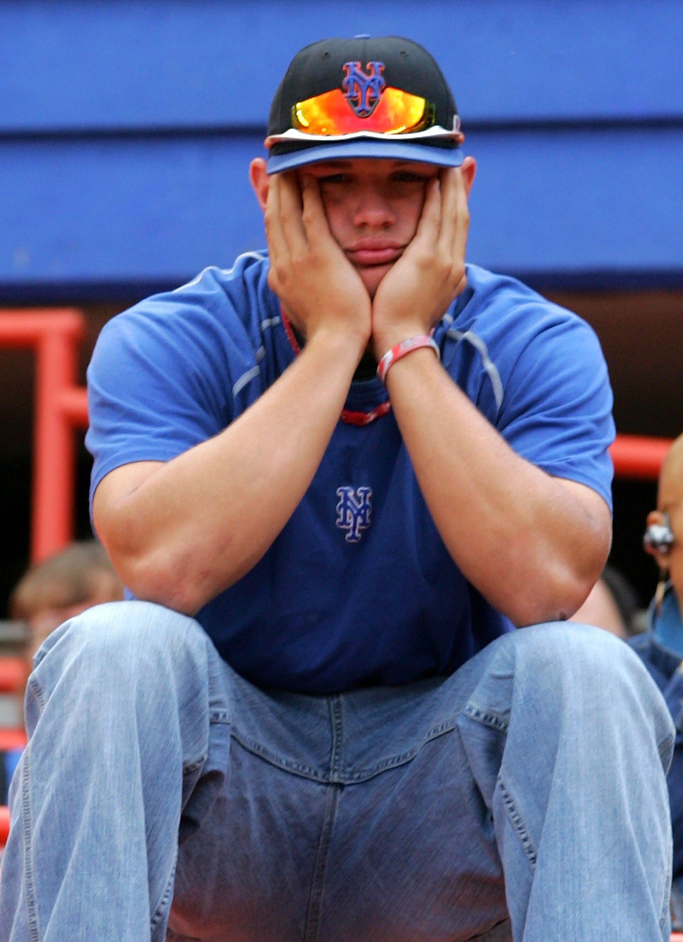 NEW YORK - SEPTEMBER 30:  A New York Mets fan reacts following the Mets' loss to the Florida Marlins during the MLB game at Shea Stadium September 30, 2007 in the Flushing neighborhood of the Queens borough of New York City. The Marlins defeated the Mets