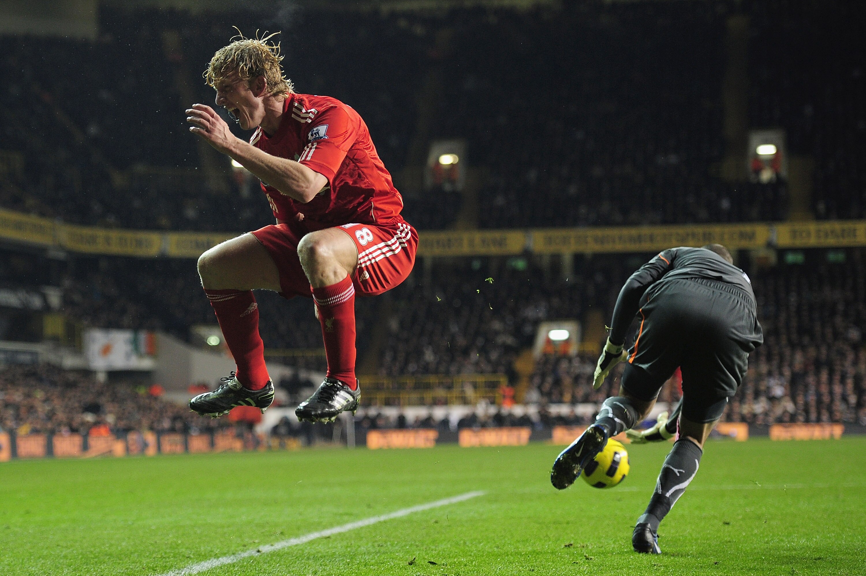 LONDON, ENGLAND - NOVEMBER 28:  Dirk Kuyt of Liverpool jumps out of the challenge by Heurelho Gomes of Tottenham Hotspur during the Barclays Premier League match between Tottenham Hotspur and Liverpool at White Hart Lane on November 28, 2010 in London, En