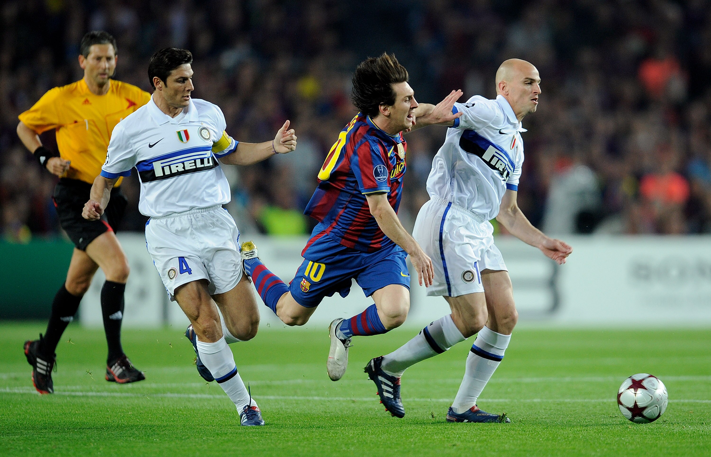 BARCELONA, SPAIN - APRIL 28: Lionel Messi of Barcelona is tackled by Javier Zanetti and Esteban Cambiasso of Inter Milan during the UEFA Champions League Semi Final Second Leg match between Barcelona and Inter Milan at Camp Nou on April 28, 2010 in Barcel