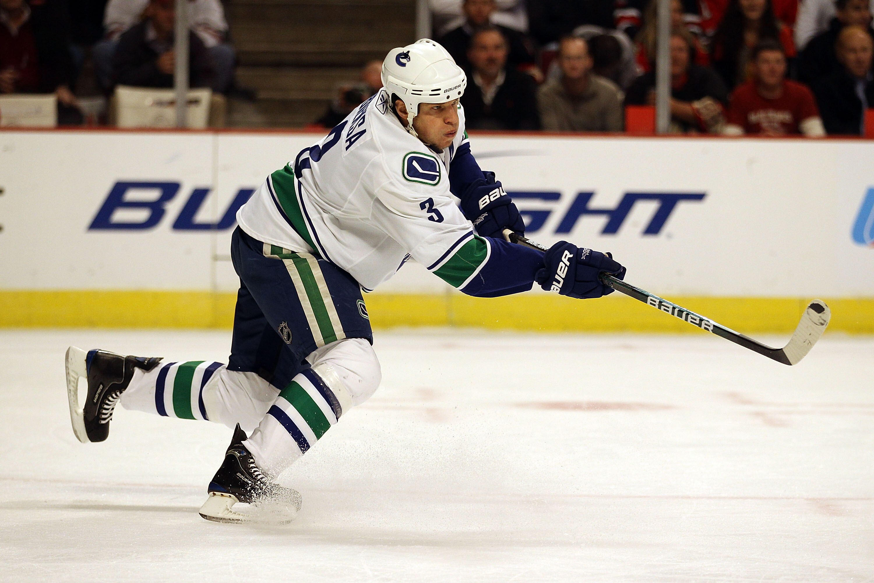 CHICAGO - OCTOBER 20: Kevin Bieksa #3 of the Vancouver Canucks shoots the puck against the Chicago Blackhawks at the United Center on October 20, 2010 in Chicago, Illinois. The Blackhawks defeated the Canucks 2-1 in a shootout. (Photo by Jonathan Daniel/G