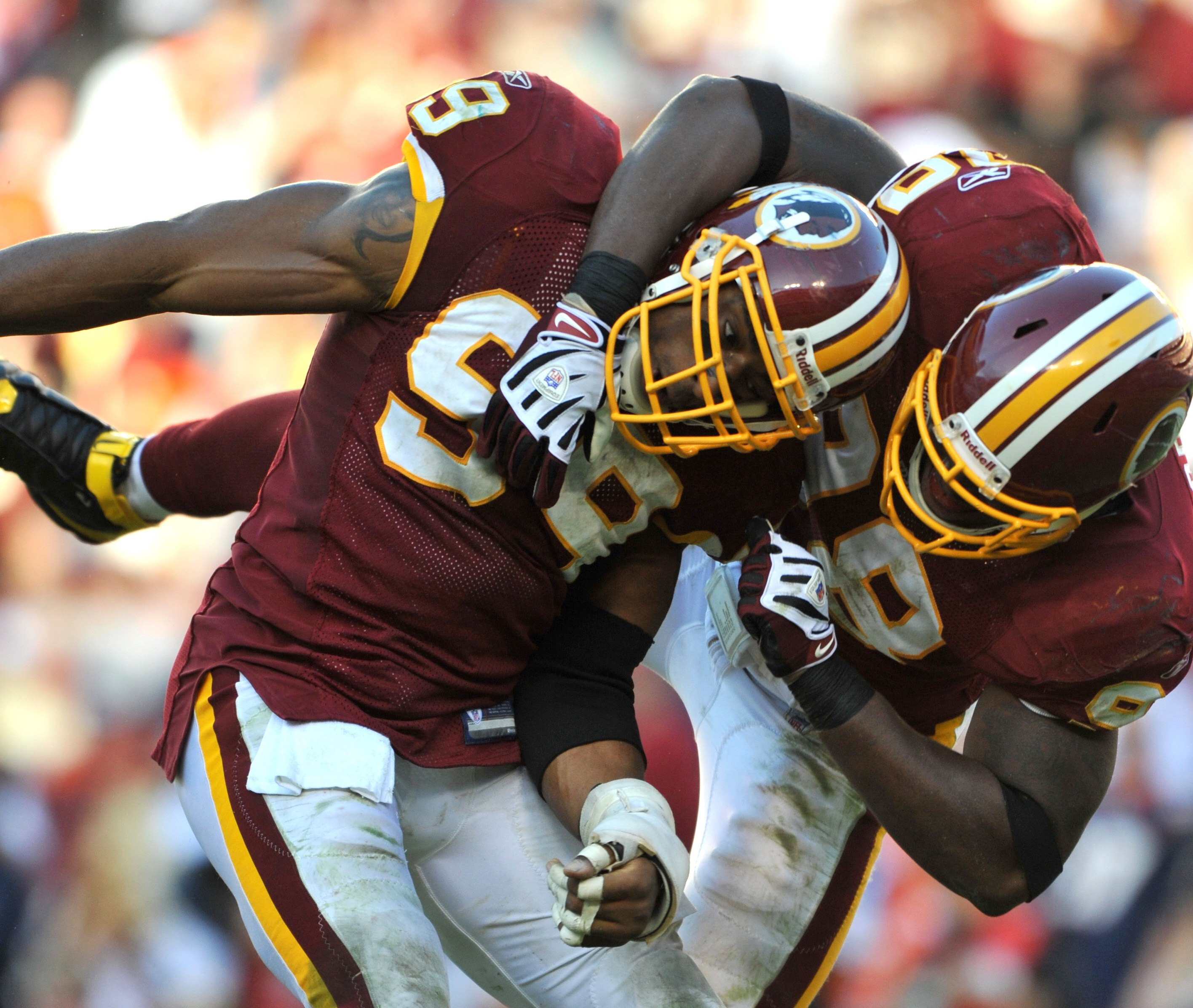 LANDOVER, MD - NOVEMBER 15:  Andre Carter #99 of the Washington Redskins celebrates a play with Brian Orakpo #98 during   the game against the Denver Broncos at FedExField on November 15, 2009 in Landover, Maryland. The Redskins won 27-17. (Photo by Larry