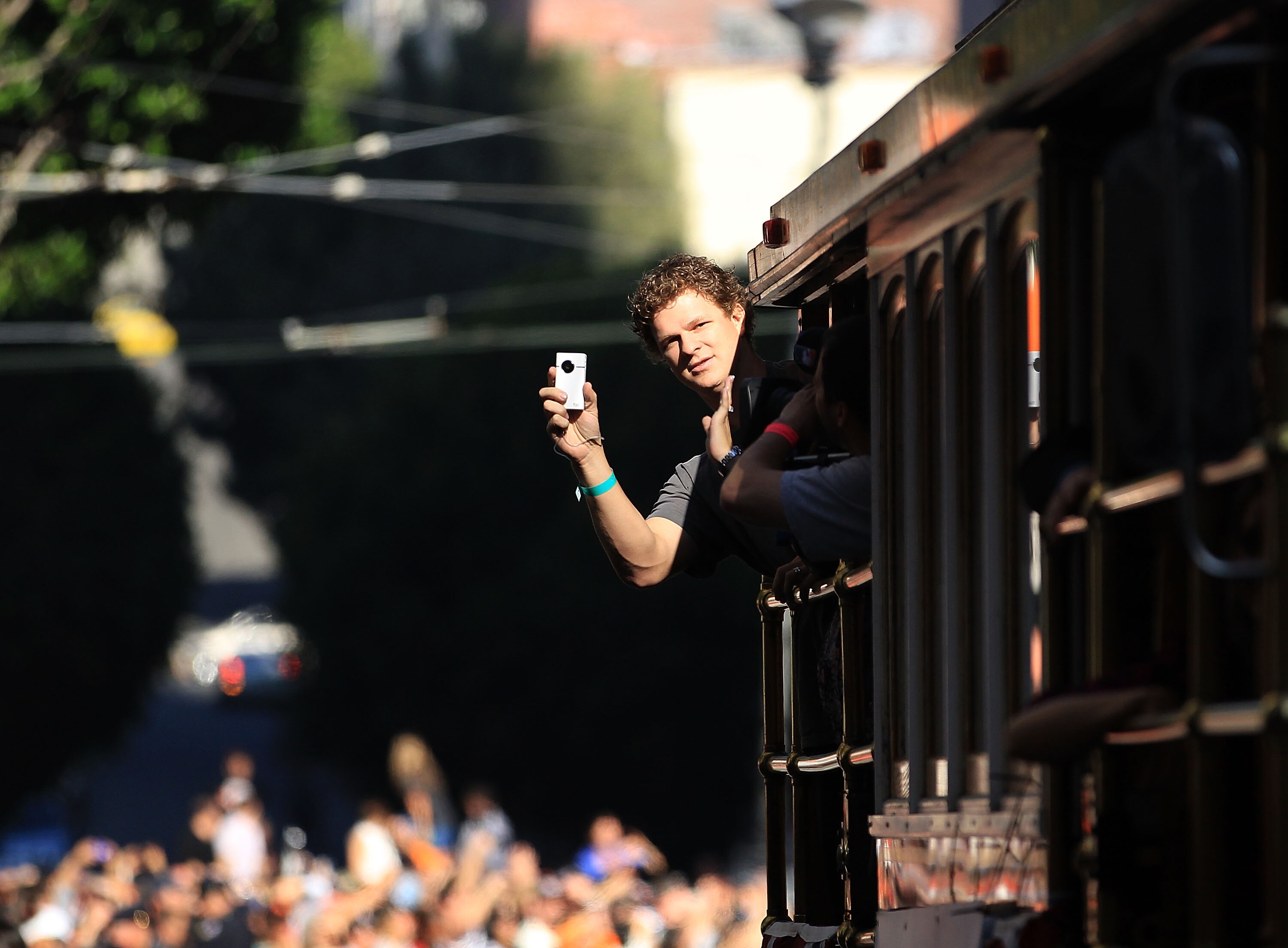 SAN FRANCISCO - NOVEMBER 03:  Matt Cain of the San Francisco Giants takes video of the crowd during the San Francisco Giants victory parade on November 3, 2010 in San Francisco, California.  (Photo by Ezra Shaw/Getty Images)