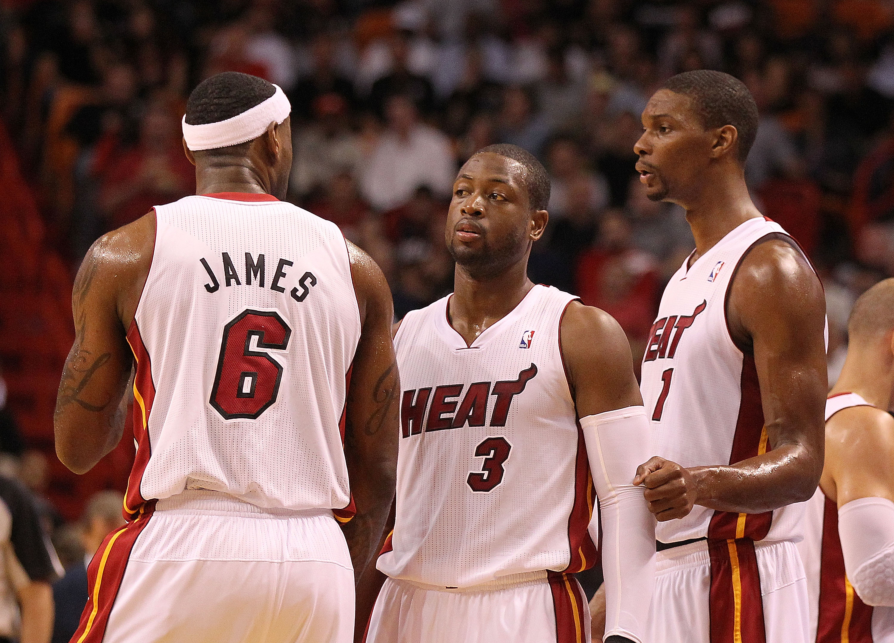 MIAMI, FL - NOVEMBER 29: LeBron James #6, Dwyane Wade #3, and Chris Bosh #1 of the Miami Heat talk during a game against the Washington Wizards at American Airlines Arena on November 29, 2010 in Miami, Florida. NOTE TO USER: User expressly acknowledges an