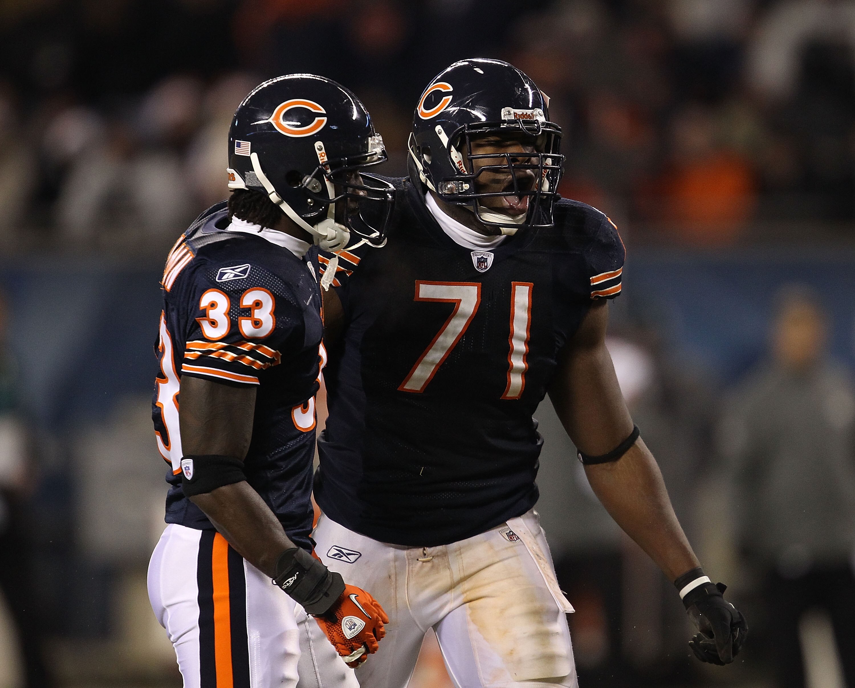 CHICAGO - NOVEMBER 28: Charles Tillman #33 and Israel Idonije #71 of the Chicago Bears celebrate a defensive stop against the Philadelphia Eagles at Soldier Field on November 28, 2010 in Chicago, Illinois. The Bears defeated the Eagles 31-26. (Photo by Jo