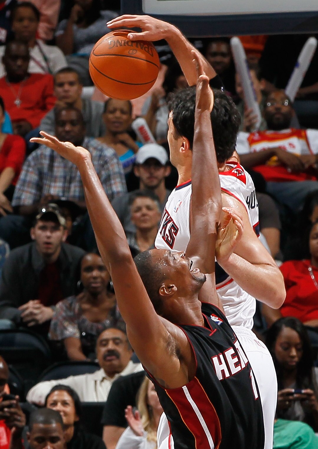 ATLANTA - OCTOBER 21:  Chris Bosh #1 of the Miami Heat against Zaza Pachulia #27 of the Atlanta Hawks at Philips Arena on October 21, 2010 in Atlanta, Georgia.  (Photo by Kevin C. Cox/Getty Images)