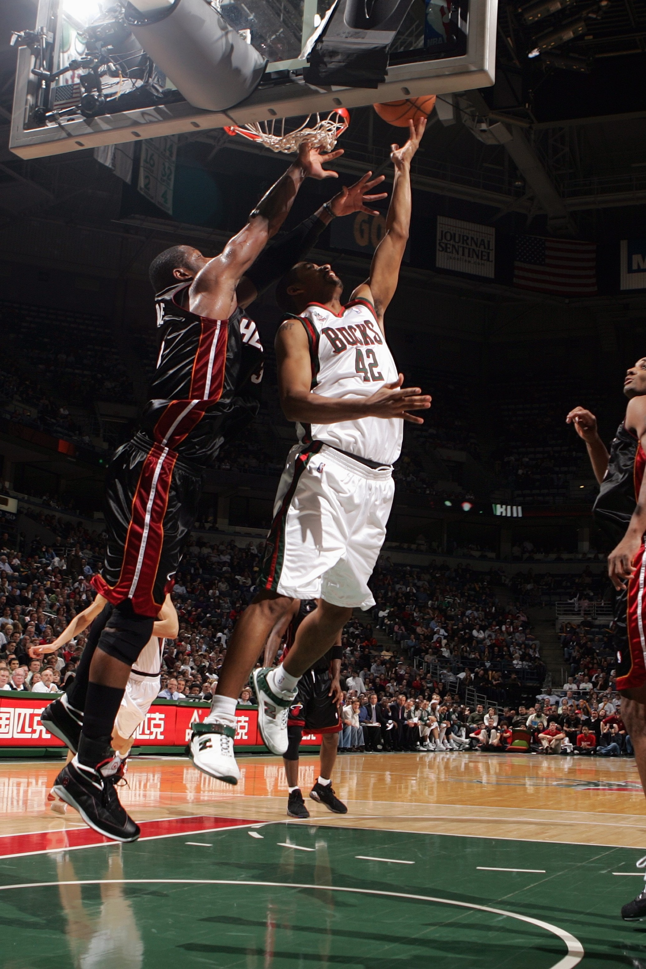 MILWAUKEE - JANUARY 9:  Charlie Bell #42 of the Milwaukee Bucks lays up a shot against Dwyane Wade #3 of the Miami Heat during the game at the Bradley Center on January 9, 2008 in Milwaukee, Wisconsin.  The Bucks won 98-92.  NOTE TO USER: User expressly a