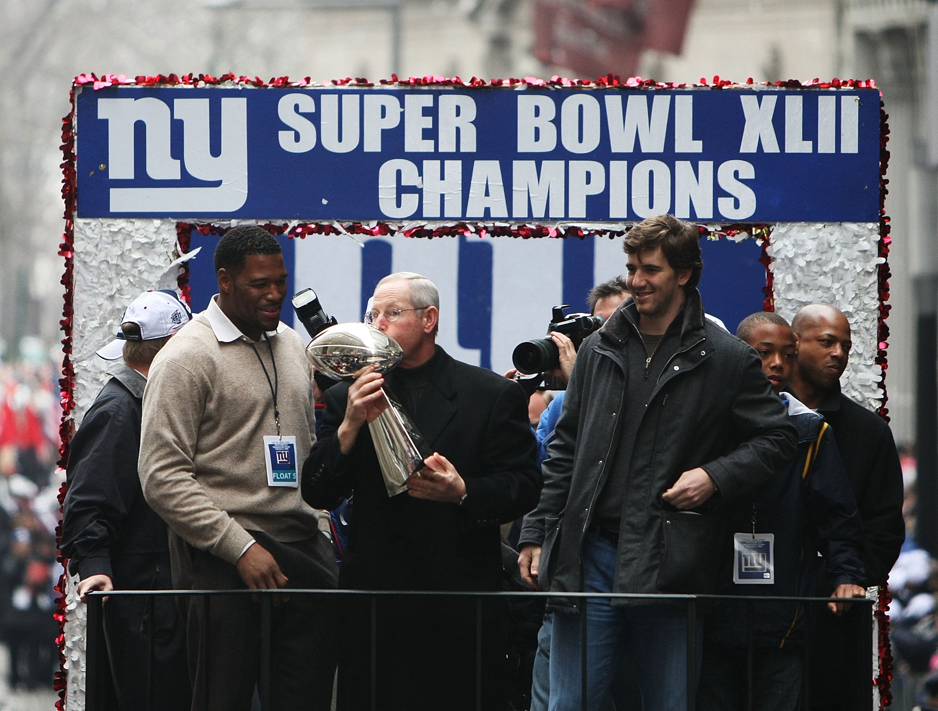 NEW YORK - FEBRUARY 05:  (L-R) Michael Strahan, Eli Manning and Head Coach Tom Coughlin of the New York Giants ride in a float along Broadway, also known as 'The Canyon of Heroes' during Super Bowl XLII victory parade in New York City.  (Photo by Al Bello