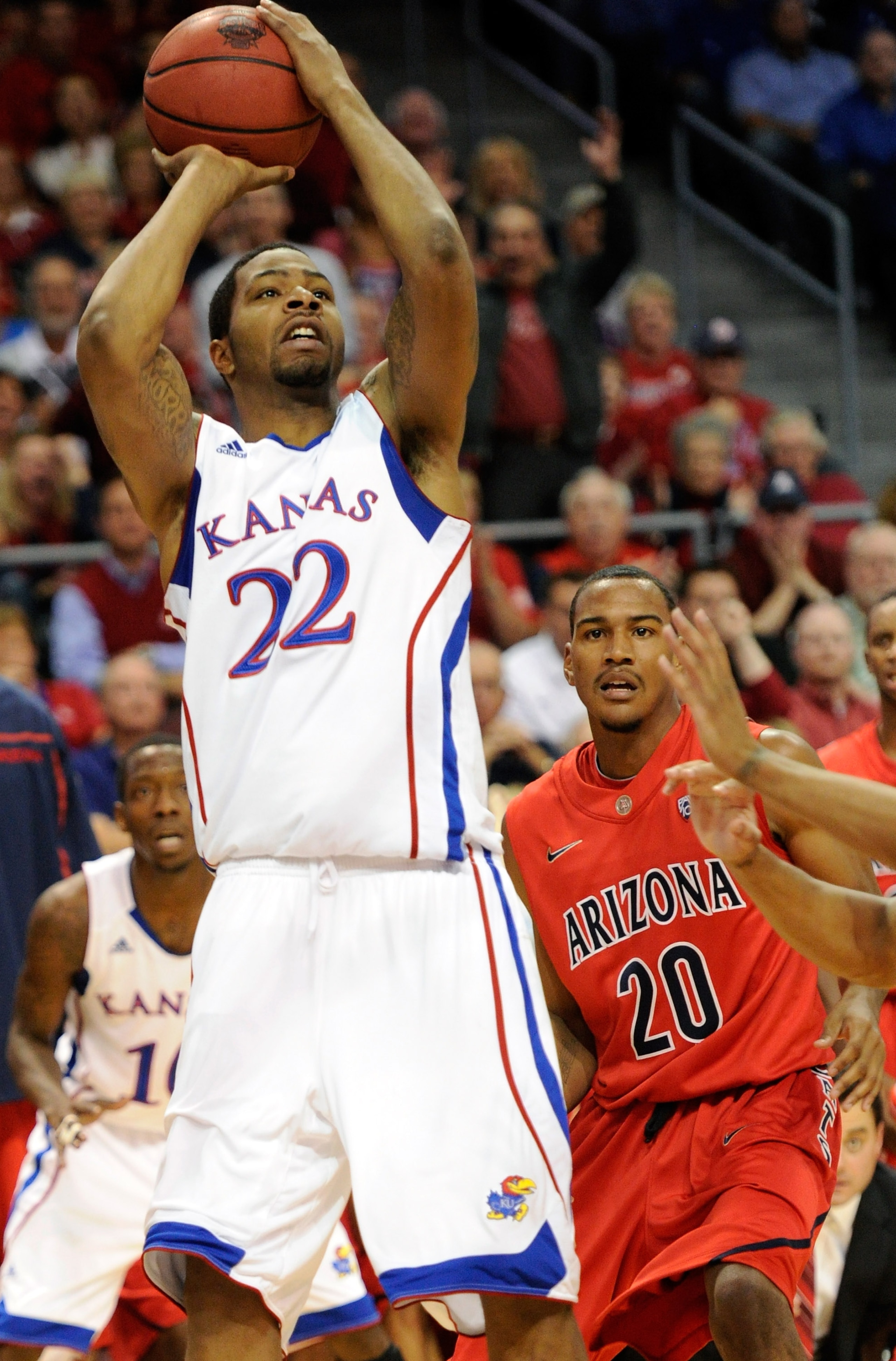 LAS VEGAS - NOVEMBER 27:  Marcus Morris #22 of the Kansas Jayhawks shoots in front of Jordin Mayes #20 of the Arizona Wildcats during the championship game of the Las Vegas Invitational at The Orleans Arena November 27, 2010 in Las Vegas, Nevada. Kansas w