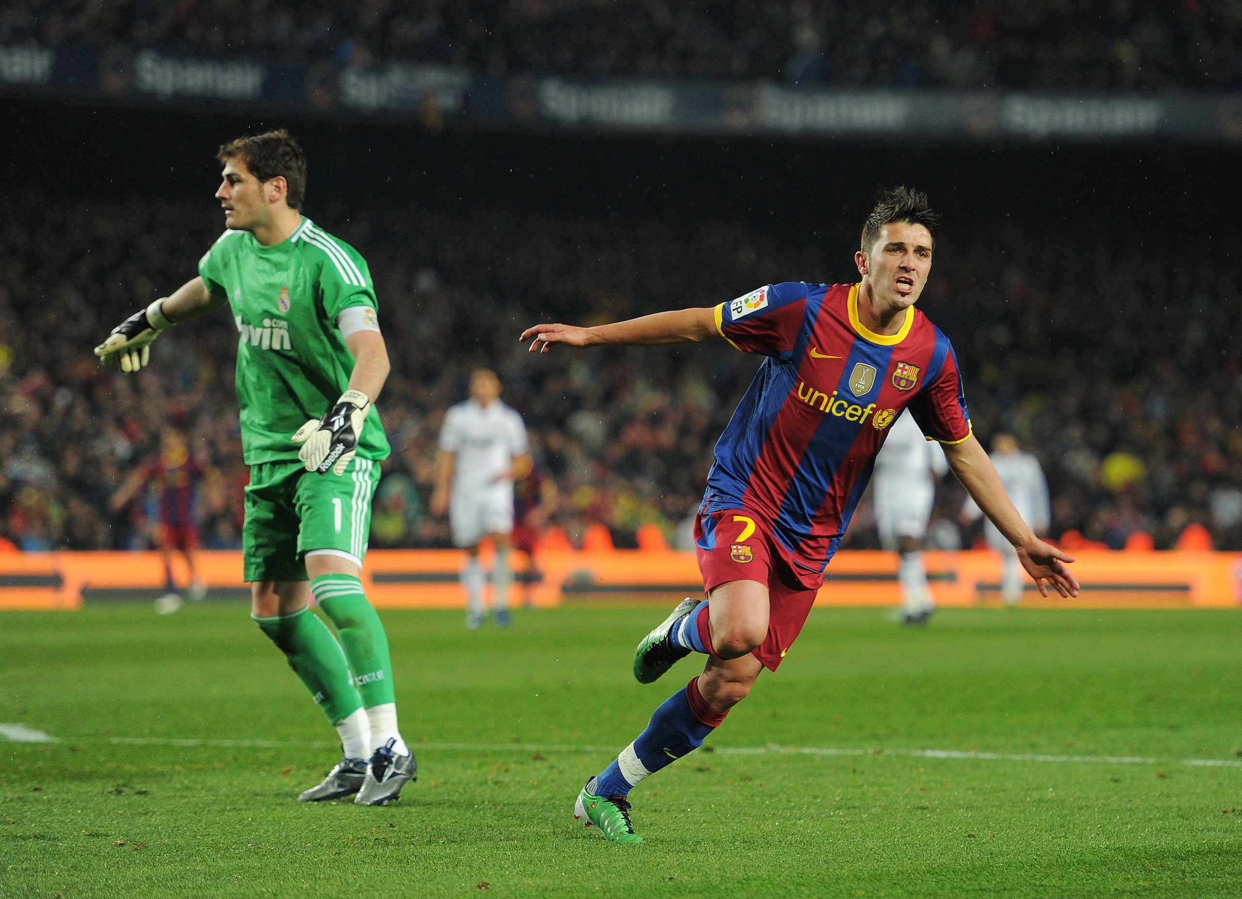 BARCELONA, SPAIN - NOVEMBER 29: David Villa (R) of Barcelona runs past goalkeeper Iker Casillas of Real Madrid as he celebrates scoring his sides fourth goal during the la liga match between Barcelona and Real Madrid at the Camp Nou stadium on November 2 BARCELONA, SPAIN - NOVEMBER 29: David Villa (R) of Barcelona runs past goalkeeper Iker Casillas of Real Madrid as he celebrates scoring his sides fourth goal during the la liga match between Barcelona and Real Madrid at the Camp Nou stadium on November 2