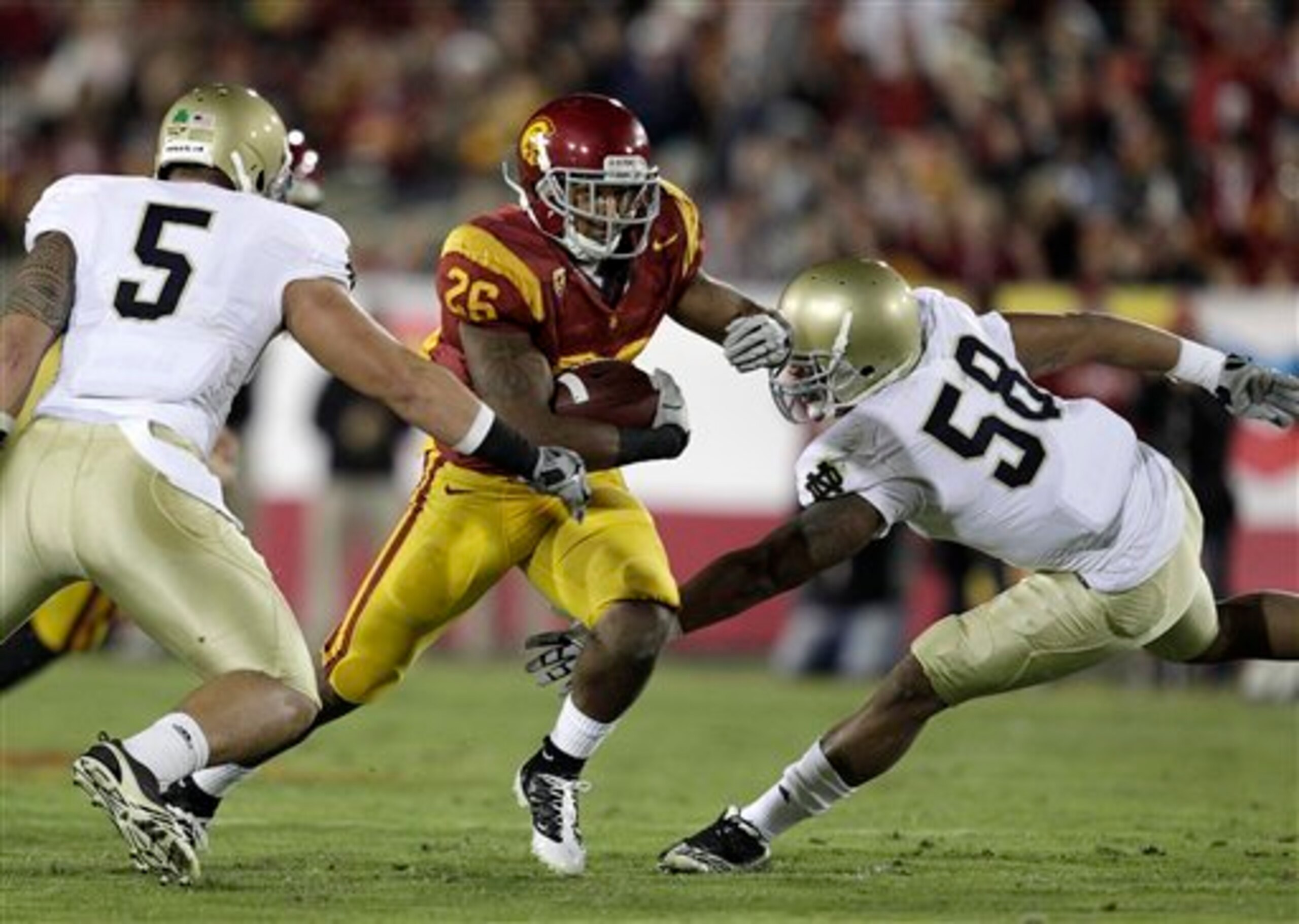 Brian Smith teams up with Manti Te'o to stuff the Trojan running attack.