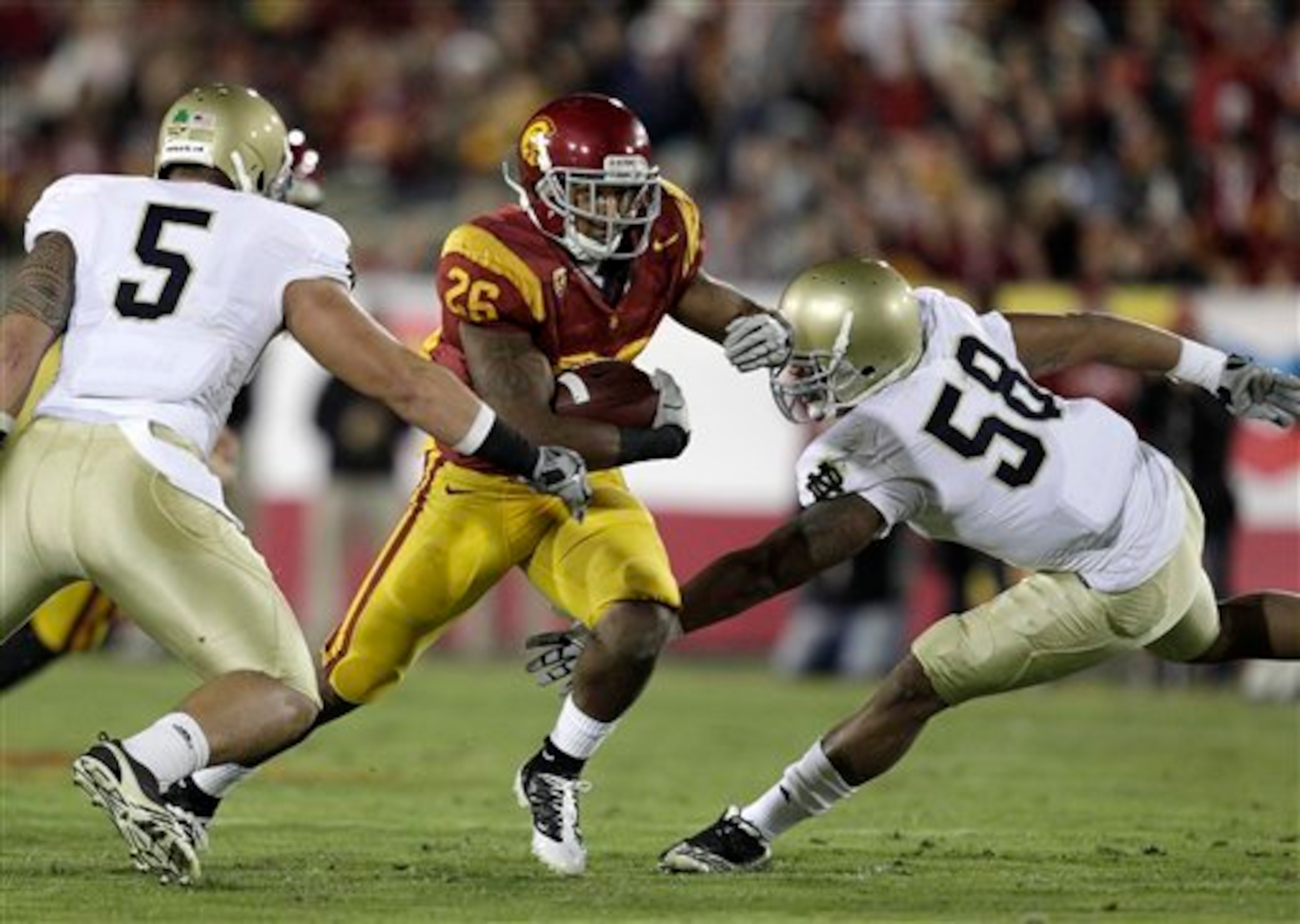 Brian Smith teams up with Manti Te'o to stuff the Trojan running attack.