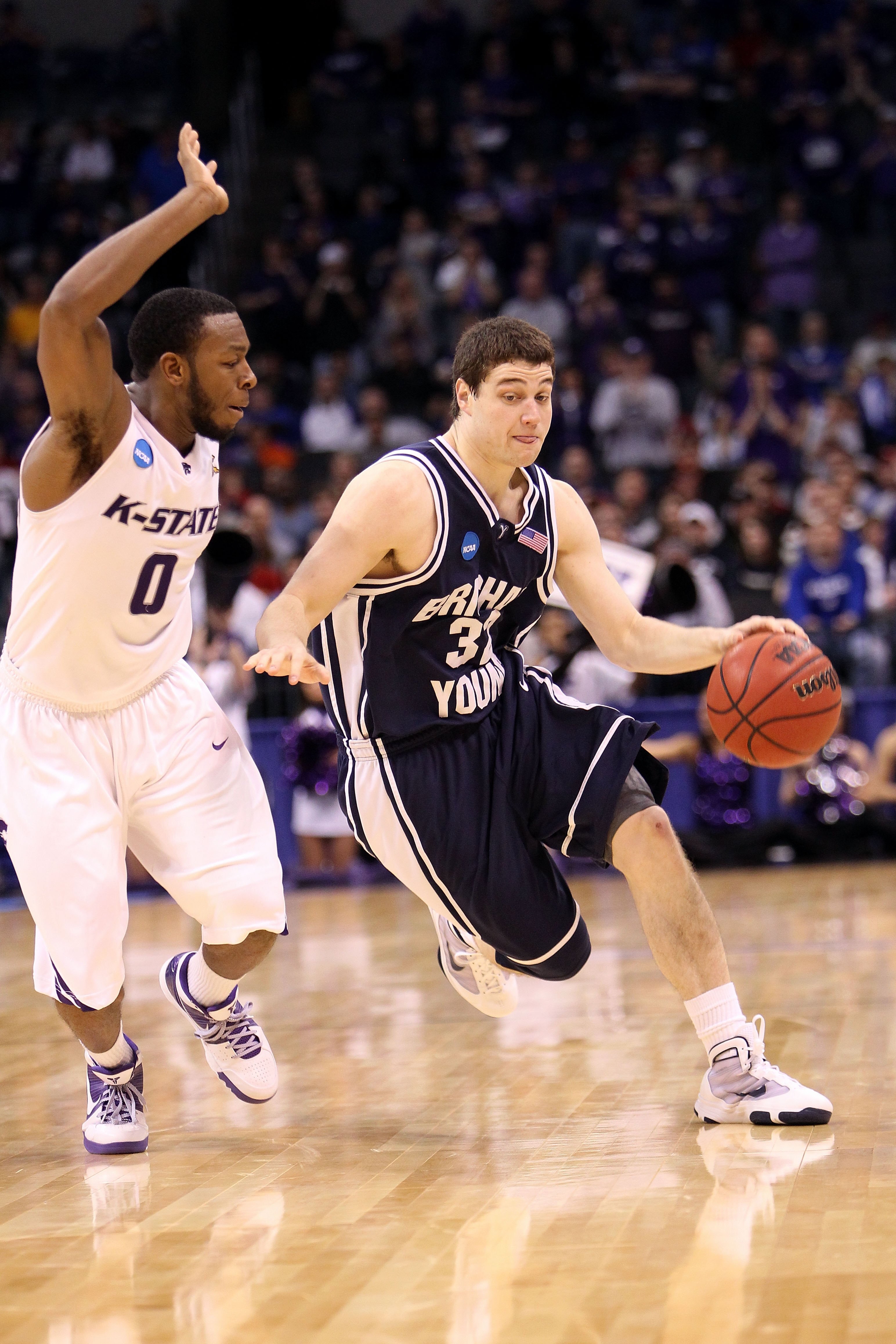 OKLAHOMA CITY - MARCH 20:  Jimmer Fredette #32 of the Brigham Young Cougars drives against Jacob Pullen #0 of the Kansas State Wildcats during the second round of the 2010 NCAA men's basketball tournament at Ford Center on March 20, 2010 in Oklahoma City,