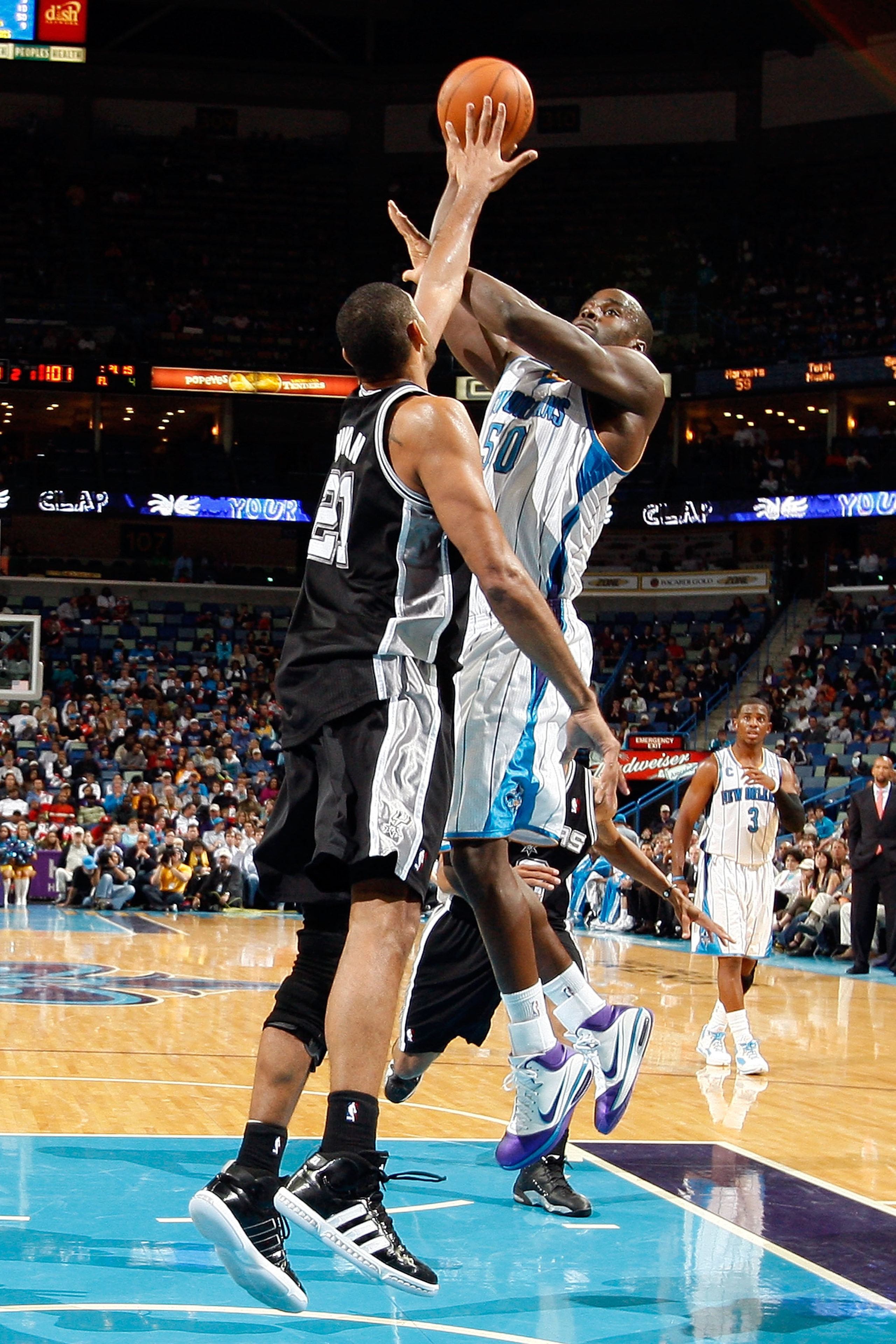 NEW ORLEANS - NOVEMBER 28: Emeka Okafor #50 of the New Orleans Hornets shoots the ball over Tim Duncan #21 of the San Antonio Spurs at the New Orleans Arena on November 28, 2010 in New Orleans, Louisiana. NOTE TO USER: User expressly acknowledges and ag NEW ORLEANS - NOVEMBER 28: Emeka Okafor #50 of the New Orleans Hornets shoots the ball over Tim Duncan #21 of the San Antonio Spurs at the New Orleans Arena on November 28, 2010 in New Orleans, Louisiana. NOTE TO USER: User expressly acknowledges and ag