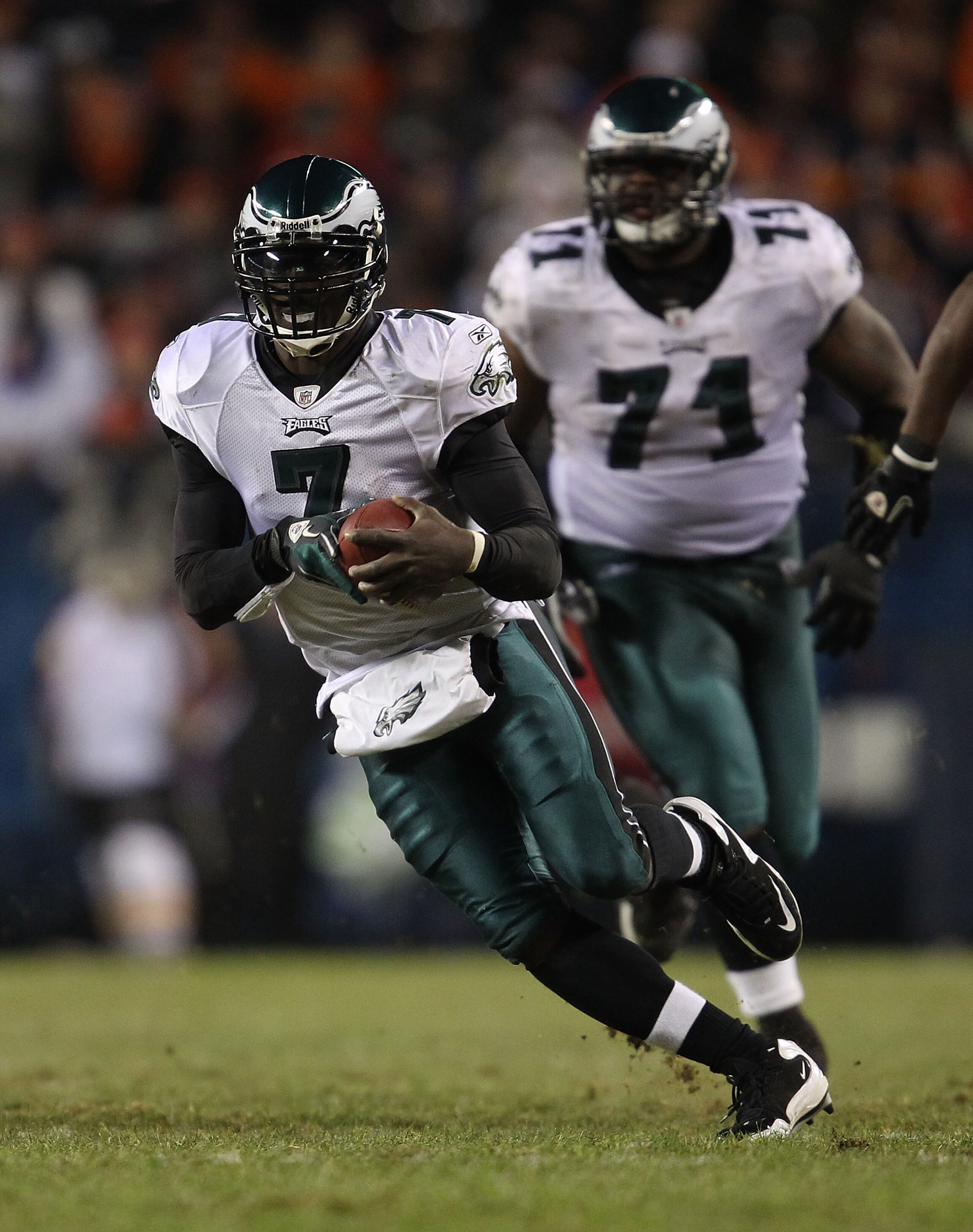 CHICAGO - NOVEMBER 28: Michael Vick #7 of the Philadelphia Eagles runs against the Chicago Bears as teammate Jason Peters #71 trails the play at Soldier Field on November 28, 2010 in Chicago, Illinois. The Bears defeated the Eagles 31-26. (Photo by Jonath