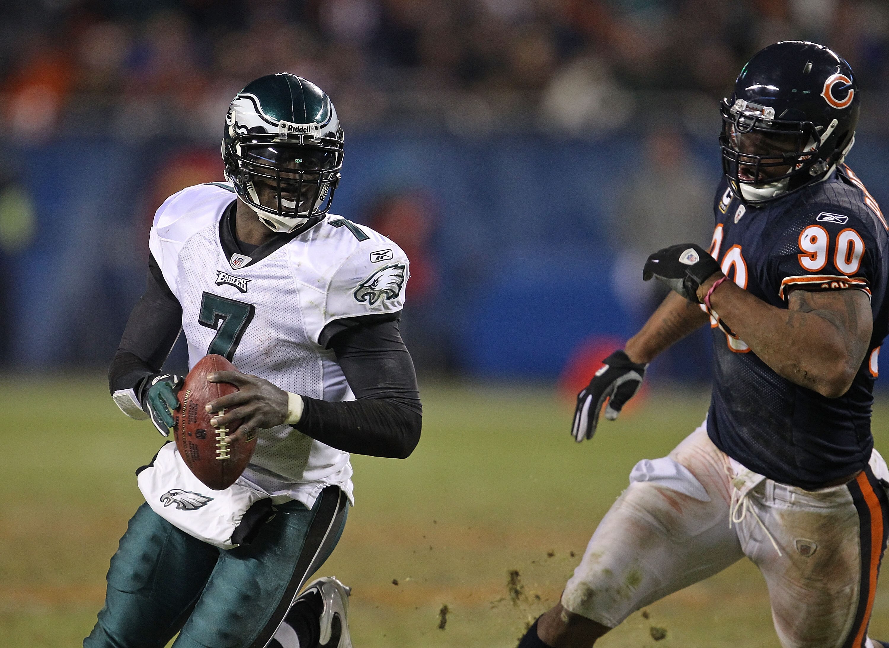 CHICAGO - NOVEMBER 28: Michael Vick #7 of the Philadelphia Eagles runs to avoid Julius Peppers #90 of the Chicago Bears at Soldier Field on November 28, 2010 in Chicago, Illinois. The Bears defeated the Eagles 31-26. (Photo by Jonathan Daniel/Getty Images