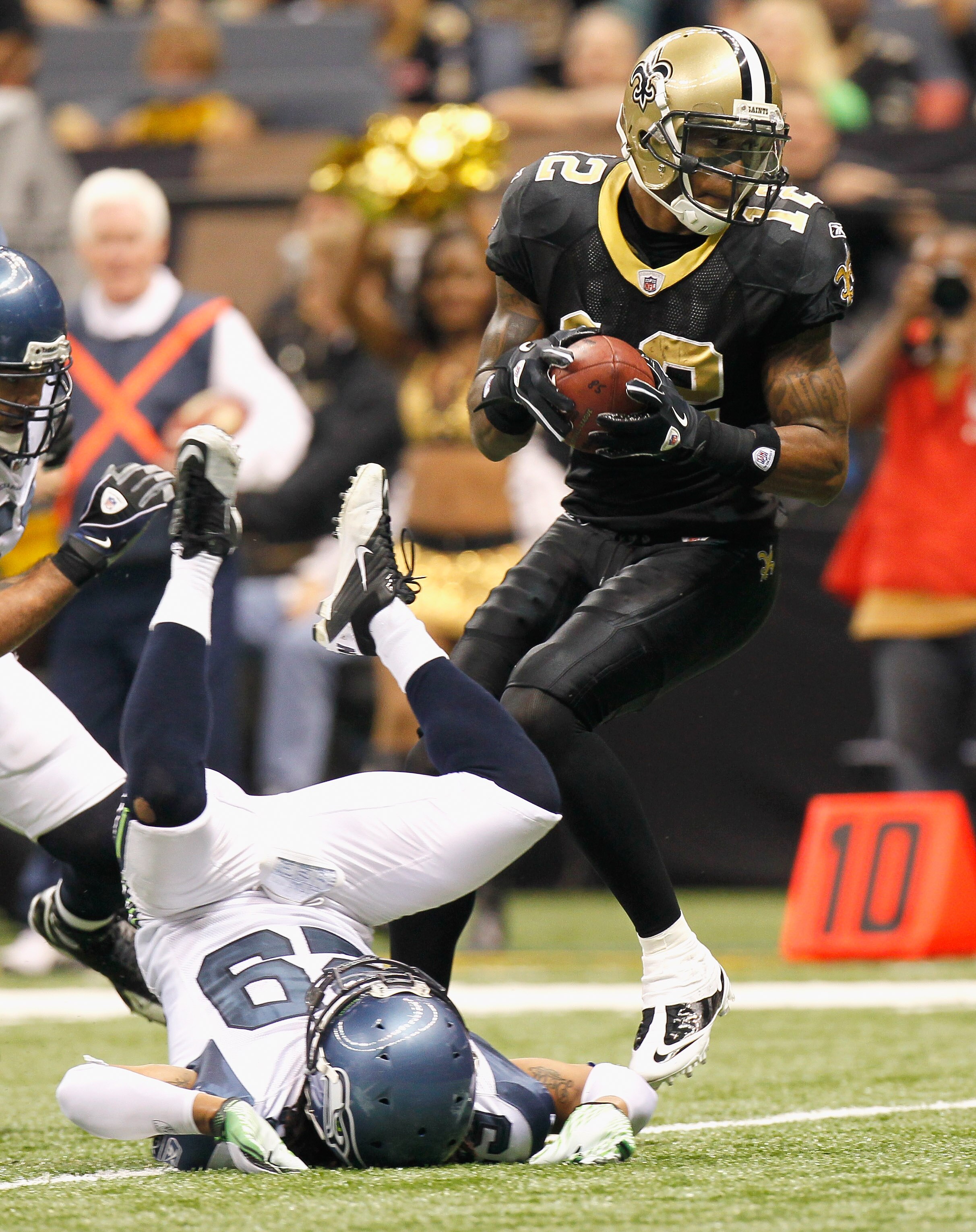 NEW ORLEANS - NOVEMBER 21:  Marques Colston #12 of the New Orleans Saints scores a touchdown after running over Earl Thomas #29 of the Seattle Seahawks at Louisiana Superdome on November 21, 2010 in New Orleans, Louisiana.  (Photo by Kevin C. Cox/Getty Im