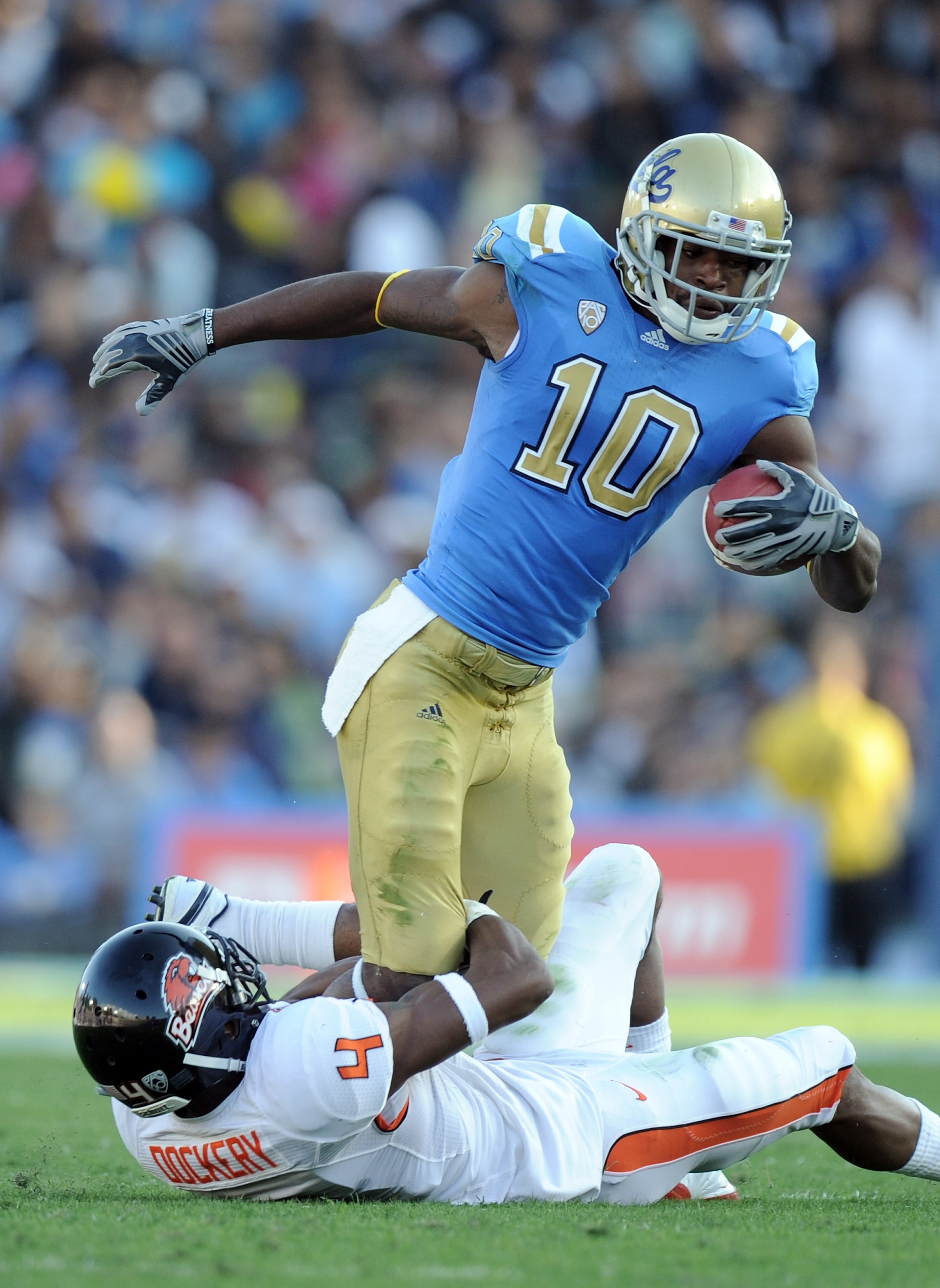 PASADENA, CA - NOVEMBER 06:  Akeem Ayers #10 of the UCLA Bruins is tackled by James Dockery #4 of the Oregon State Beavers during the first quarter at the Rose Bowl on November 6, 2010 in Pasadena, California.  (Photo by Harry How/Getty Images)