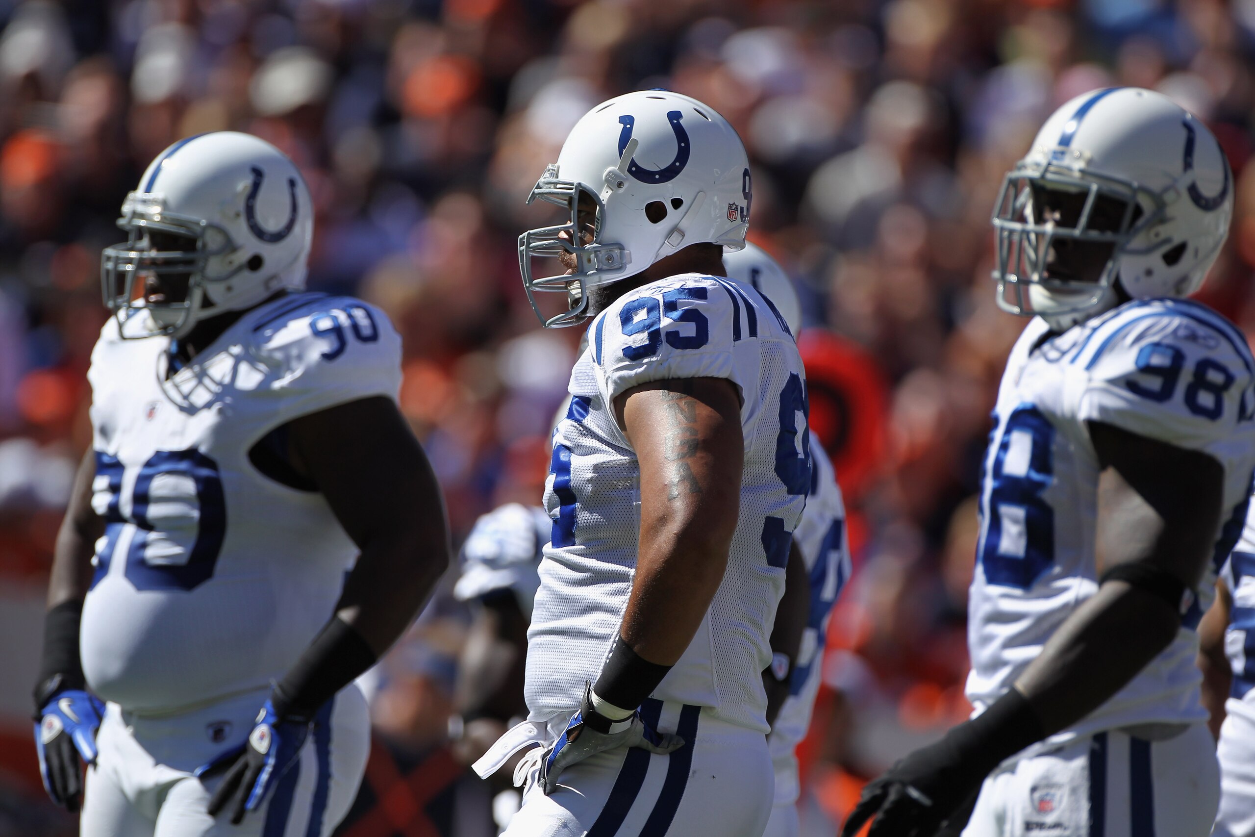 DENVER - SEPTEMBER 26:  Defensive linemen Dan Muir #90, Fili Moala #95 and Robert Mathis #98 of the Indianapolis Colts prepare to play defense against the Denver Broncos at INVESCO Field at Mile High on September 26, 2010 in Denver, Colorado. The Colts de