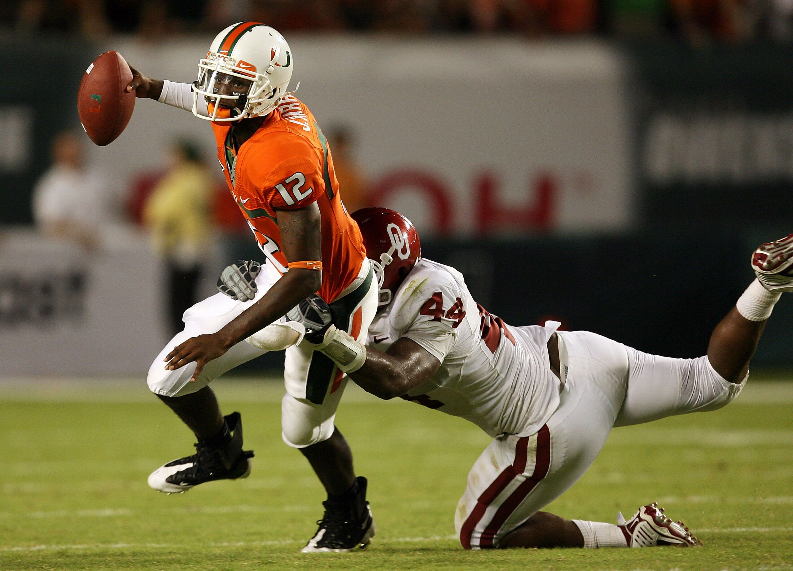 FORT LAUDERDALE, FL - OCTOBER 03: Quarterback Jacory Harris #12 of the Miami Hurricanes is sacked by defensive end Jeremy Beal #44 of the Oklahoma Sooners at Land Shark Stadium on October 3, 2009 in Fort Lauderdale, Florida. Miami defeated Oklahoma 21-20. FORT LAUDERDALE, FL - OCTOBER 03: Quarterback Jacory Harris #12 of the Miami Hurricanes is sacked by defensive end Jeremy Beal #44 of the Oklahoma Sooners at Land Shark Stadium on October 3, 2009 in Fort Lauderdale, Florida. Miami defeated Oklahoma 21-20.
