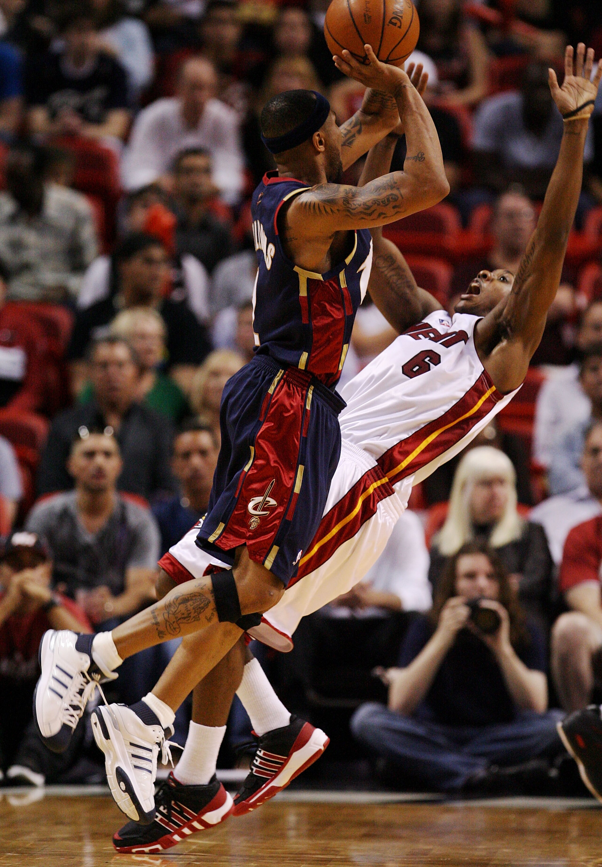 MIAMI - DECEMBER 30:  Mario Chalmers #6 of the Miami Heat draws an offensive foul on Mo Williams #2 of the Cleveland Cavaliers at American Airlines Arena on December 30, 2008 in Miami, Florida. The Heat defeated the Cavaliers 104-95. NOTE TO USER: User ex