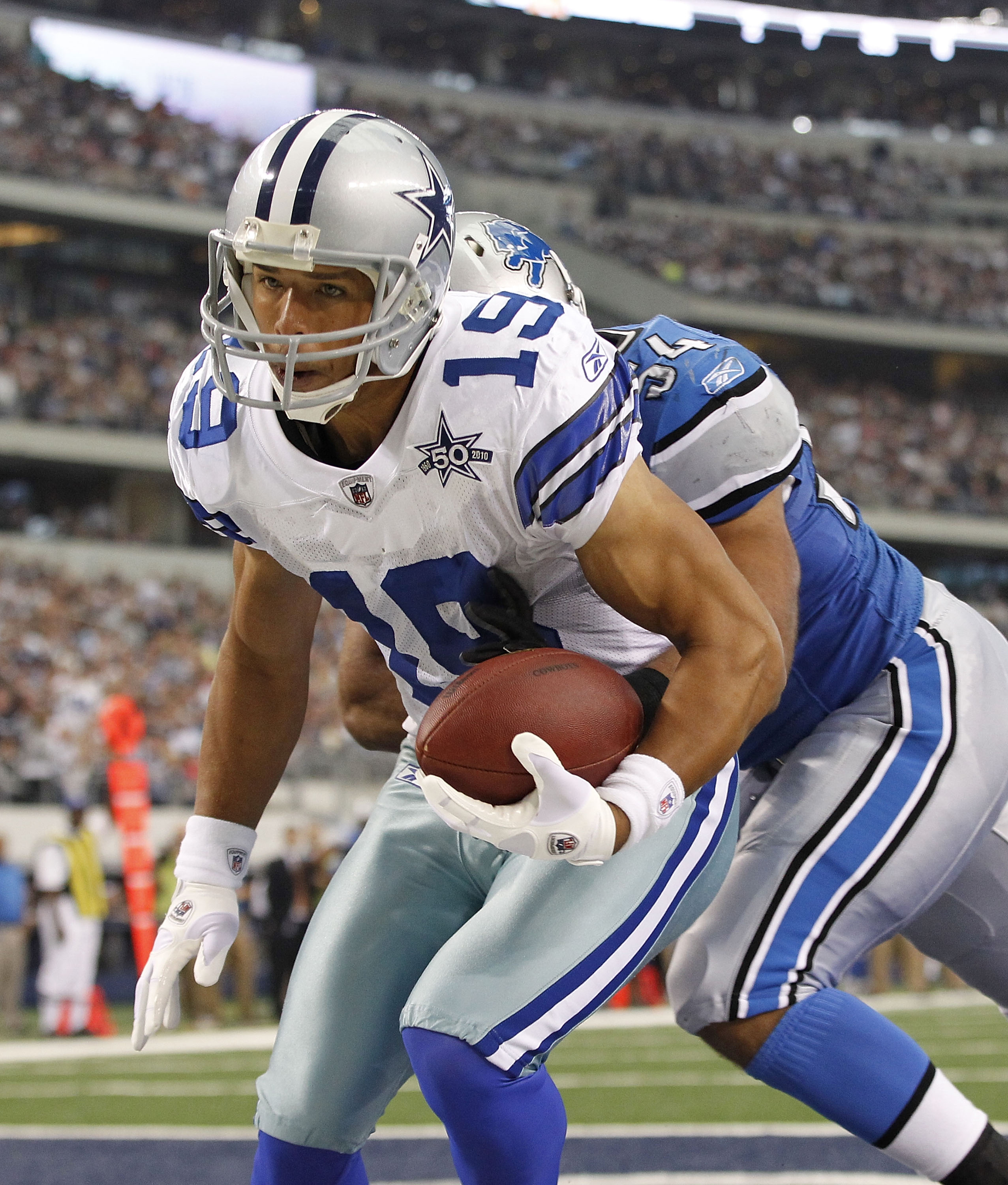 ARLINGTON, TX - NOVEMBER 21: Miles Austin #19 of the Dallas Cowboys scores a third quarter touchdown on a 3 yard pass from Jon Kitna #3 as DeAndre Levy #54 of the Detroit Lions defends during the game at Dallas Stadium on November 21, 2010 in Arlington, T